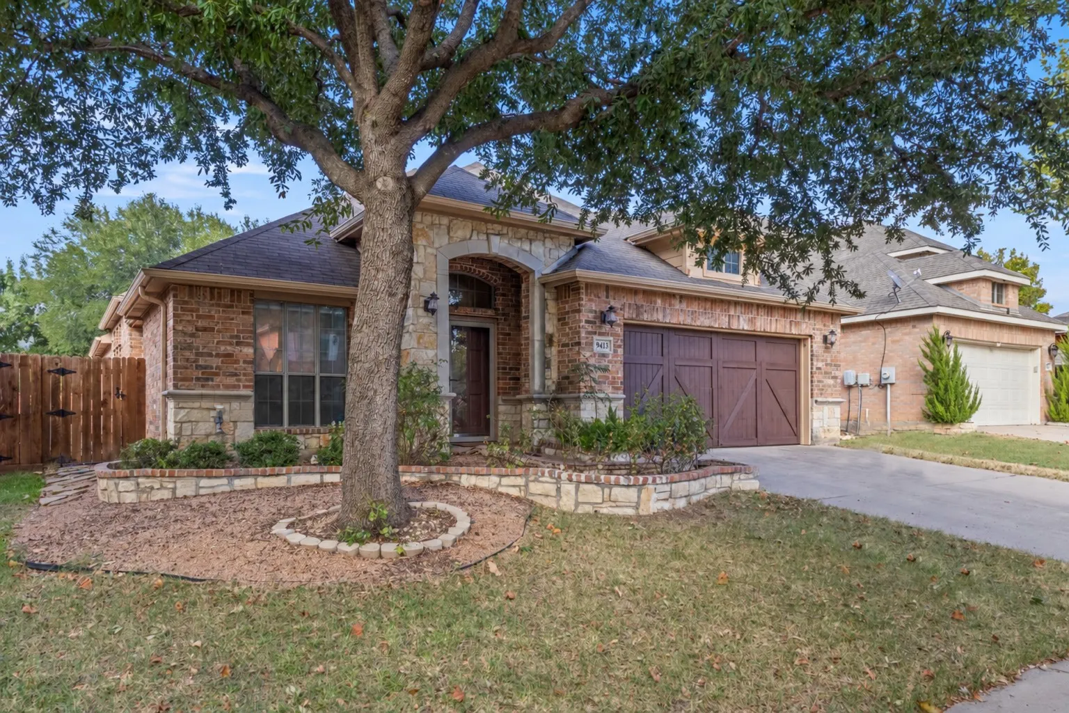 Brick and stone exterior with an arched entry