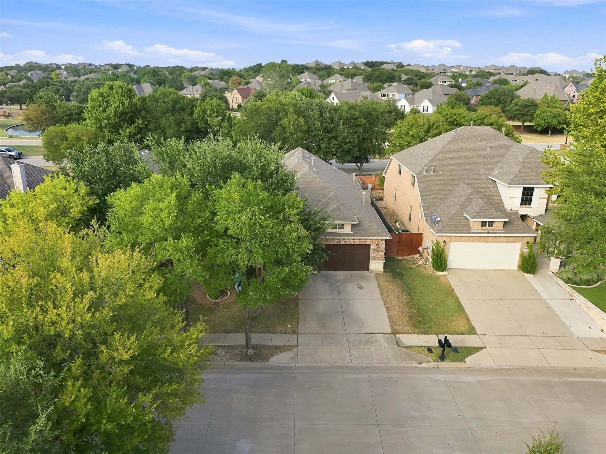 Brick exterior home with an attached two-car garage and a paved driveway