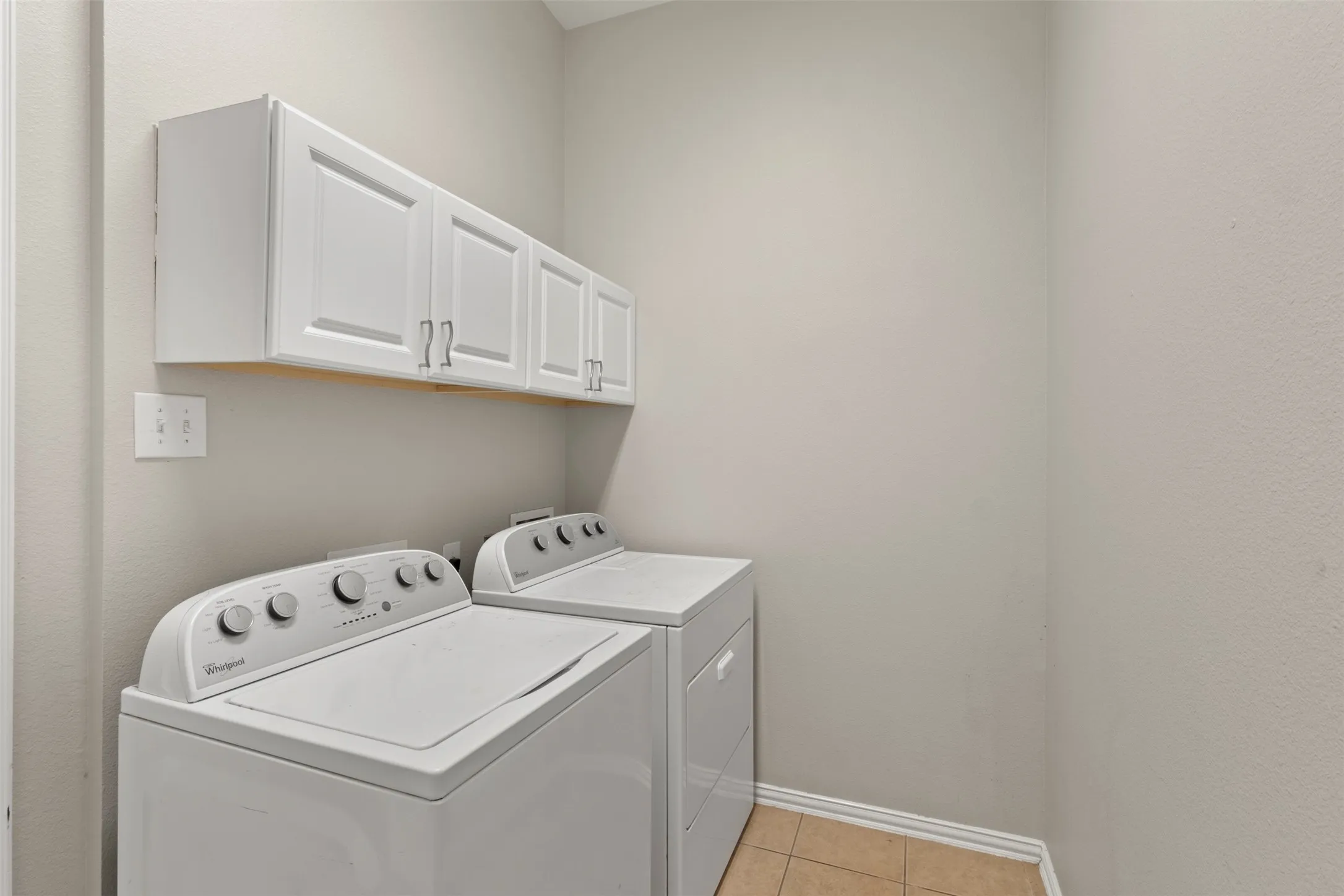 White upper cabinetry with panel doors and brushed nickel hardware