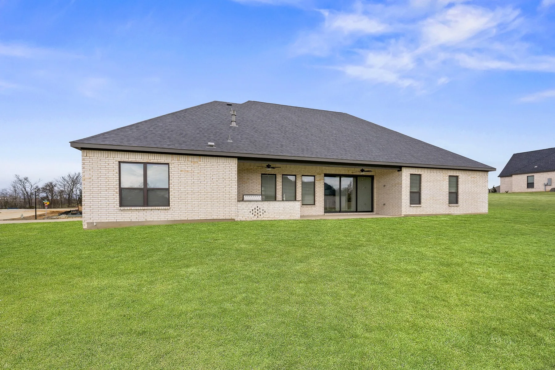 The beautiful Mantle floor plan built at 132 Willow Oak Drive with an outdoor kitchen and covered patio.