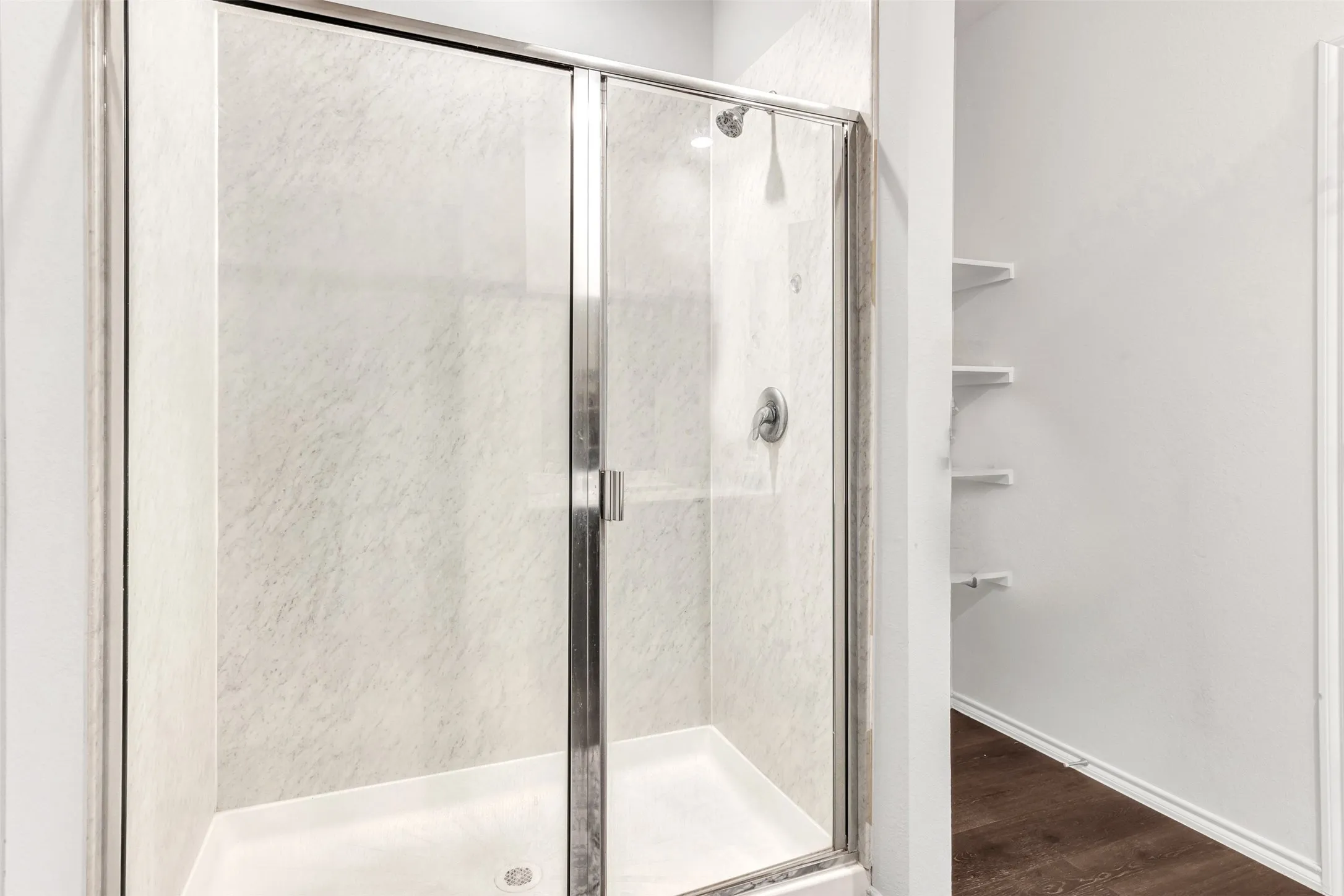 Bathroom with wood-type flooring and an enclosed shower