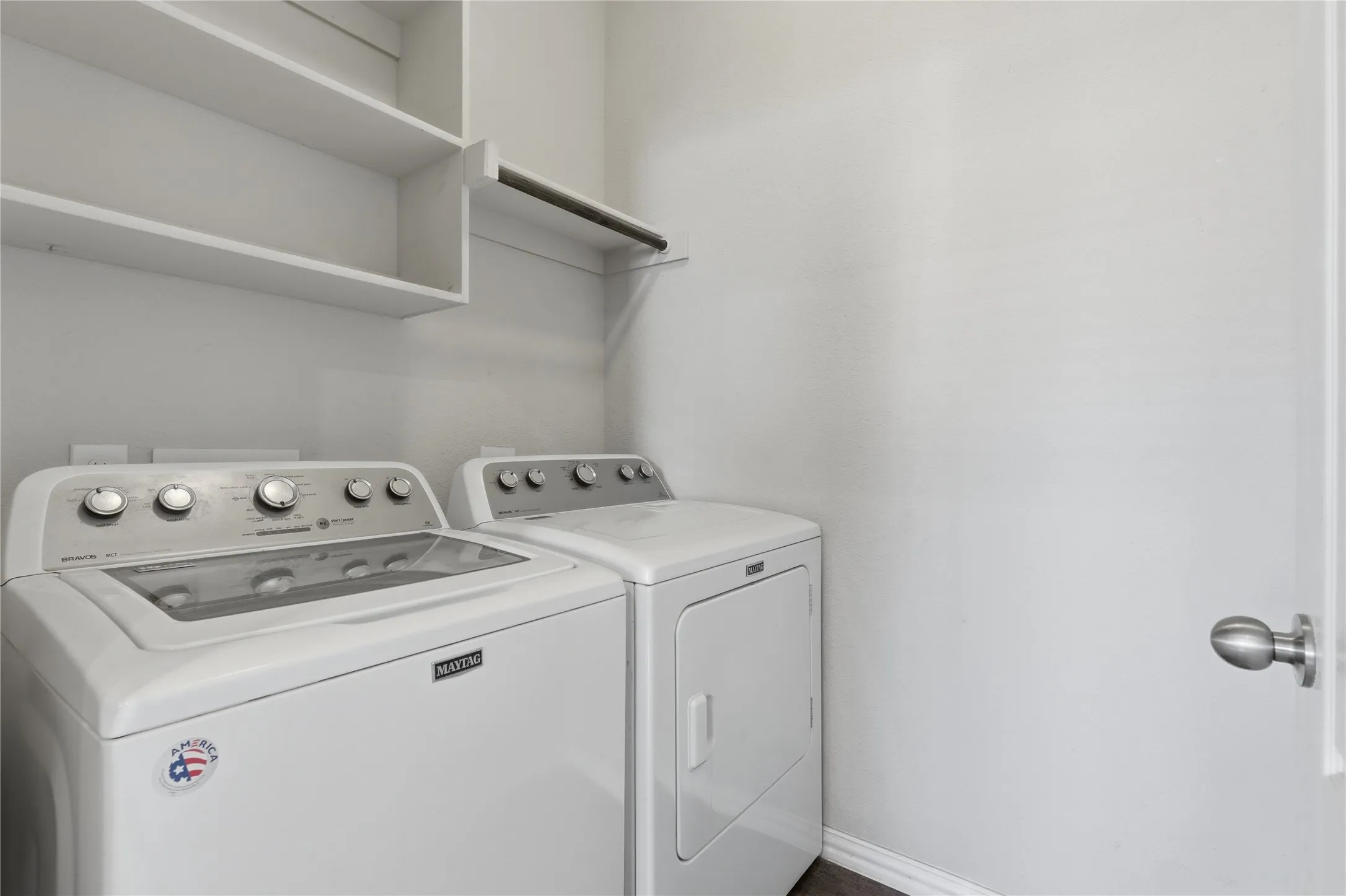 Laundry area with built-in shelving and hanging rod