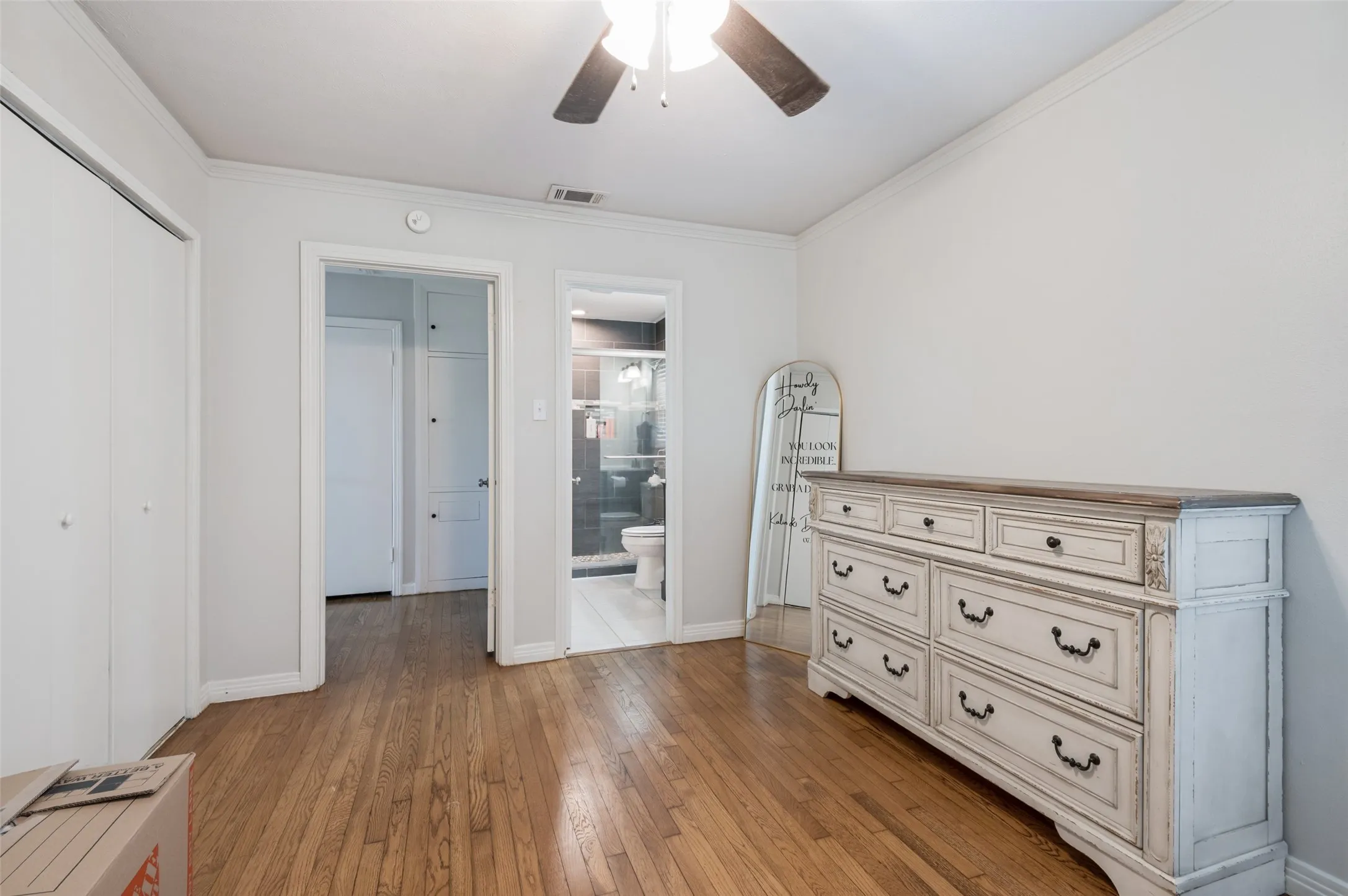 Wood-finish flooring with white walls and trim