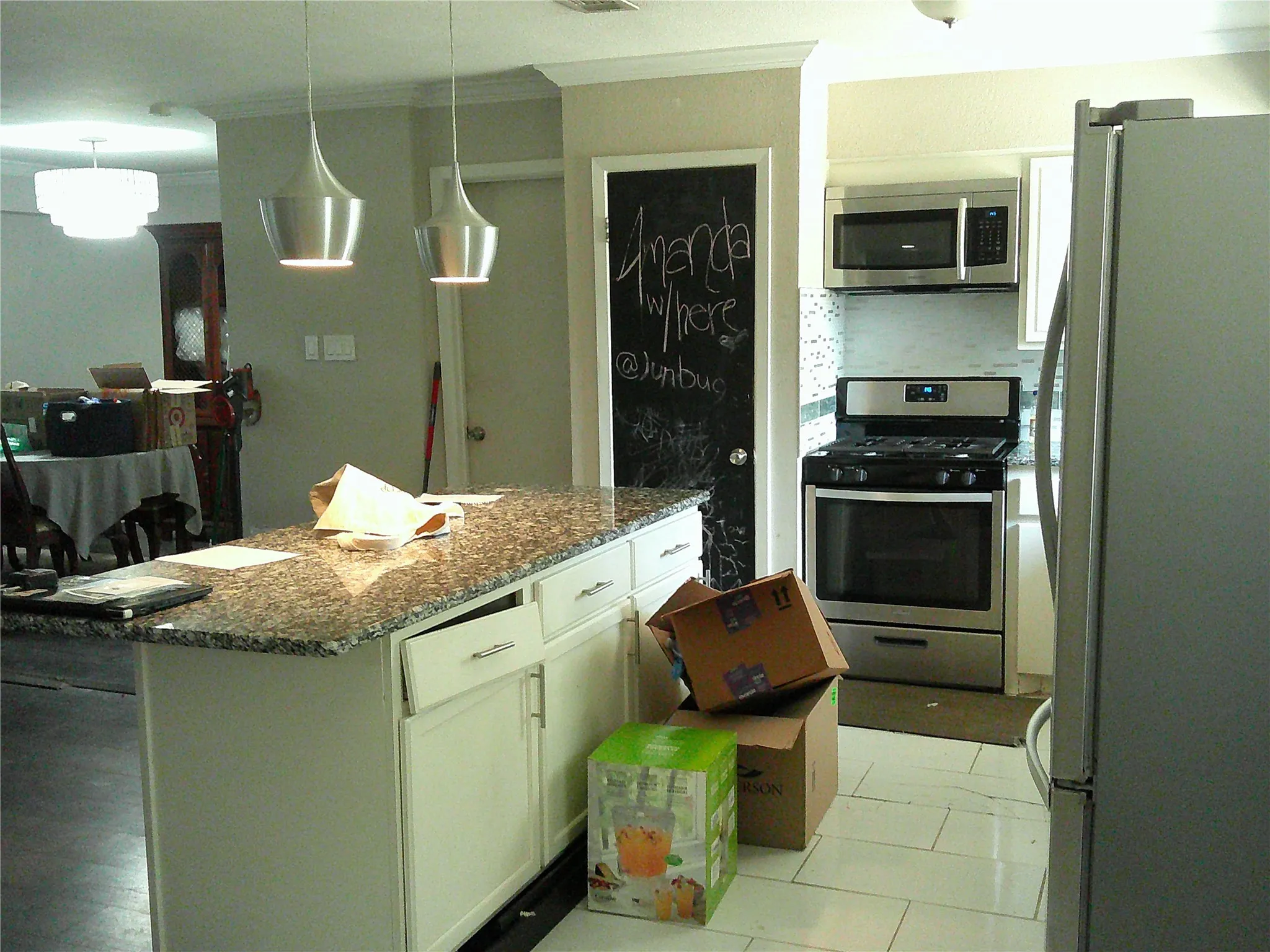 Kitchen featuring a granite-top island with white cabinetry, stainless steel range, and coordinating​​‌​​​​‌​​‌‌​‌‌​​​‌‌​‌​‌​‌​​​‌​​ microwave