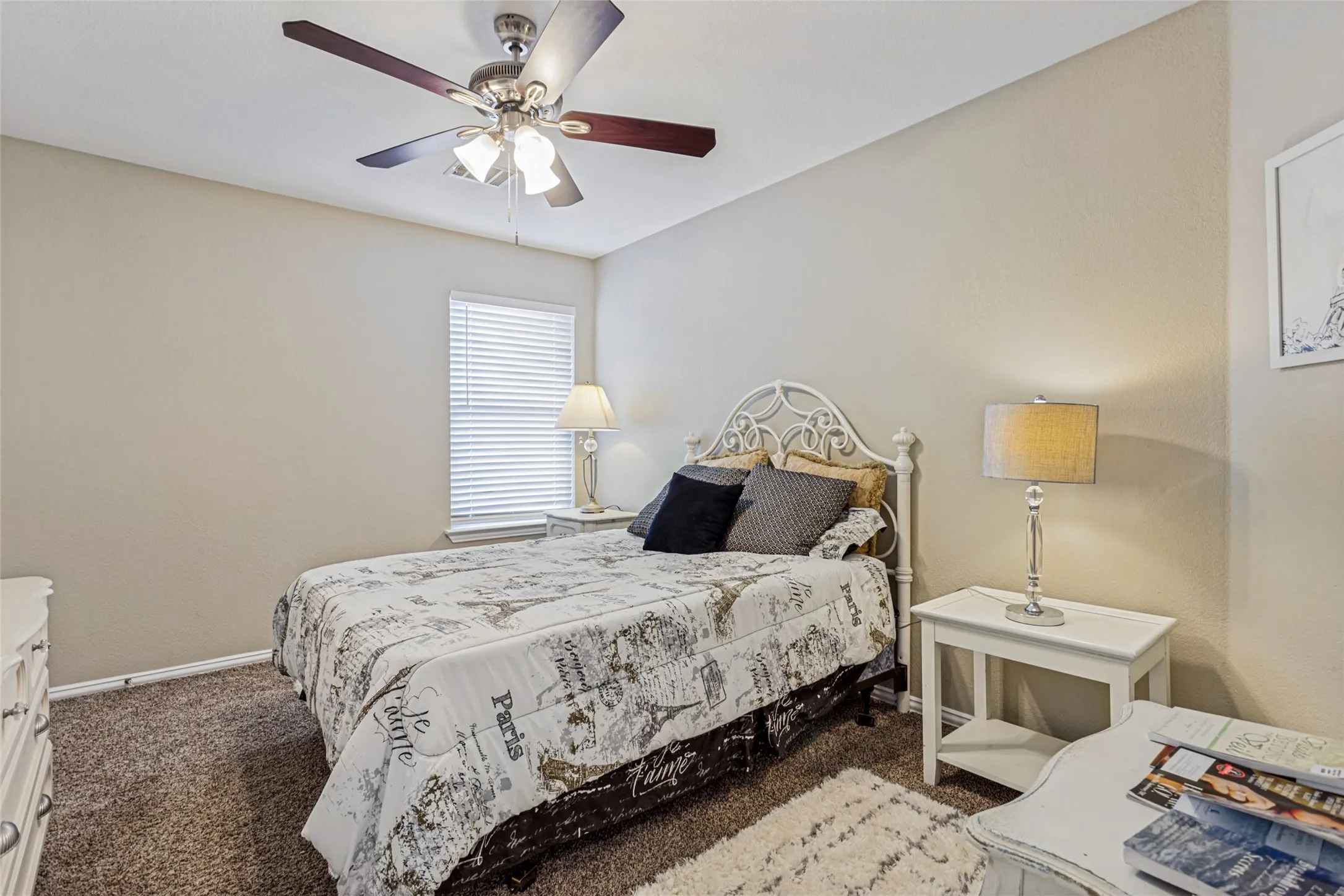 Neutral wall paint, textured carpet, ceiling fan with integrated lighting, window with blinds, and white trim