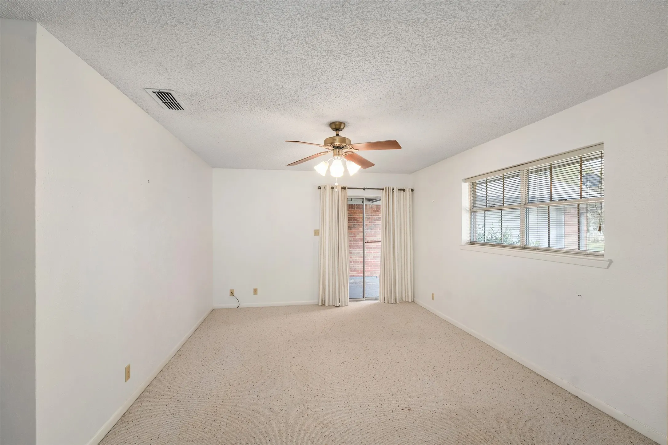 Primary bedroom with door to patio