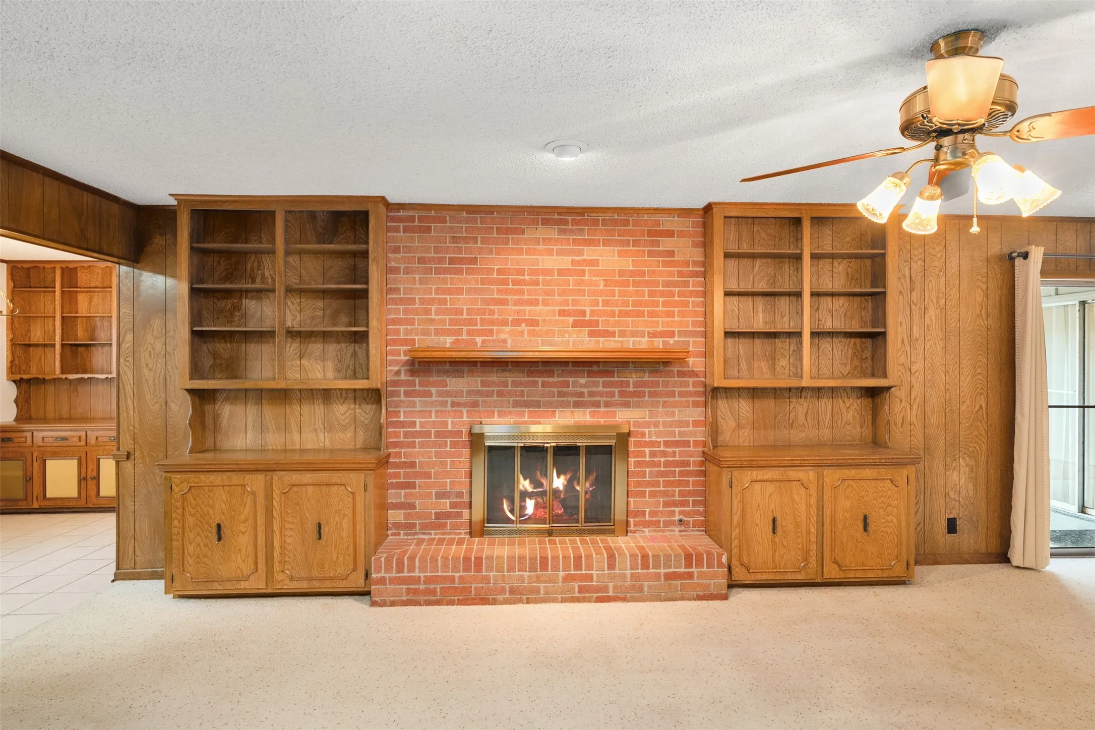 Living with wood burning fireplace and built in cabinets