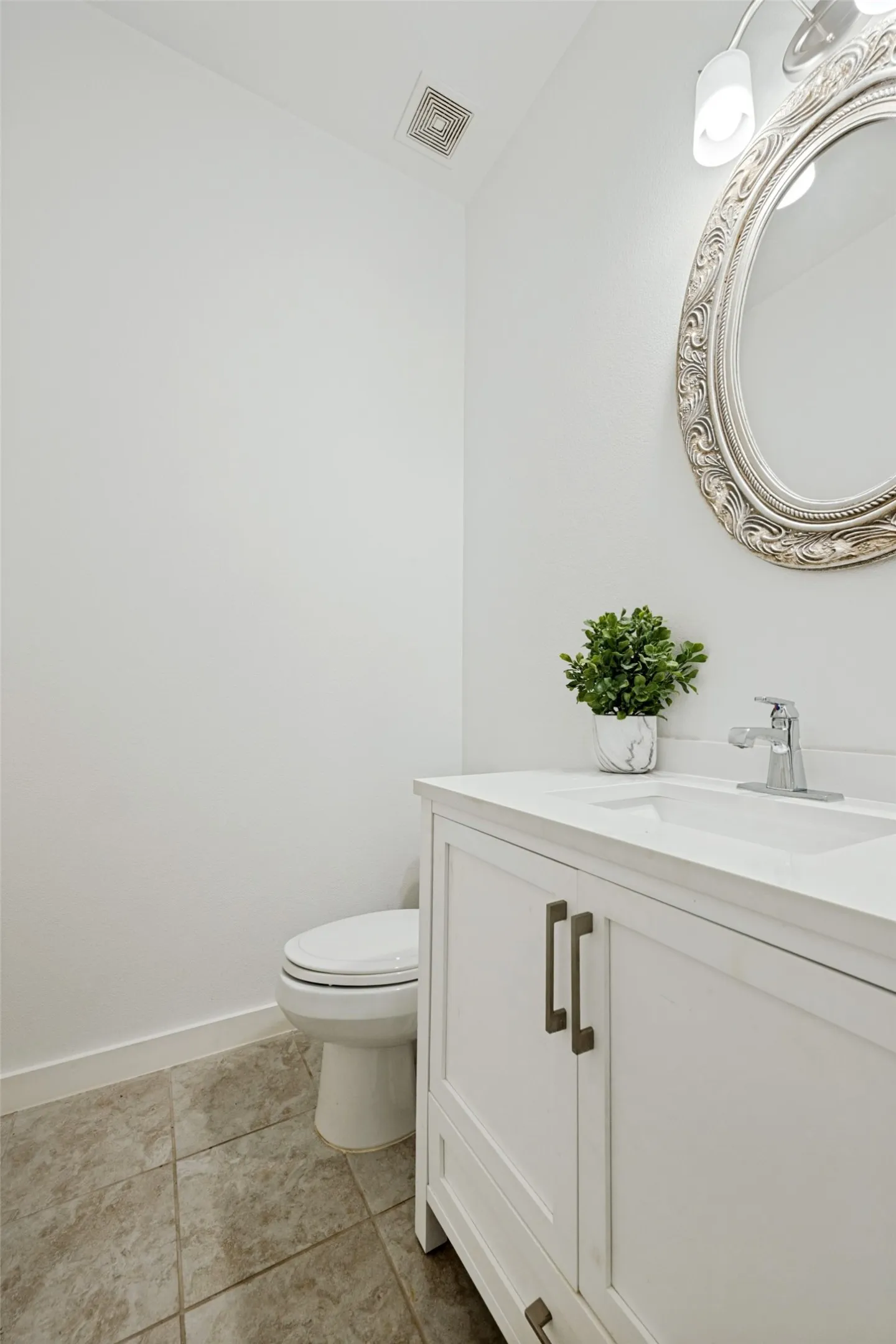 White vanity with brushed nickel hardware, integrated sink, and chrome faucet