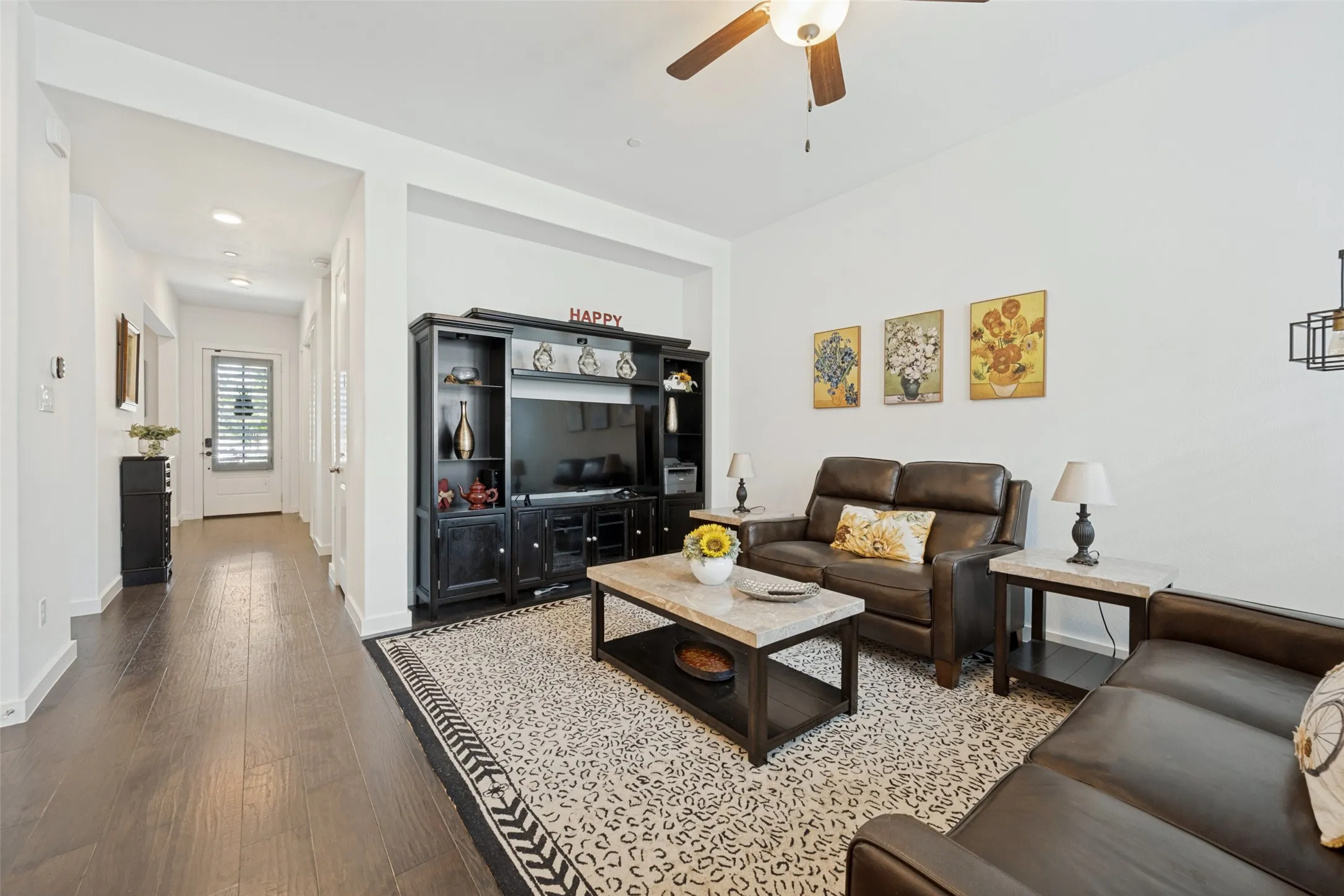 Spacious living area featuring wood-finish flooring, recessed lighting, and a ceiling fan