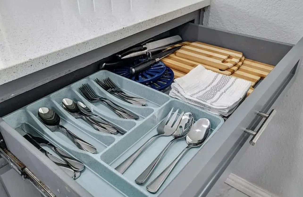 Drawer with light gray cabinetry and modern bar pulls