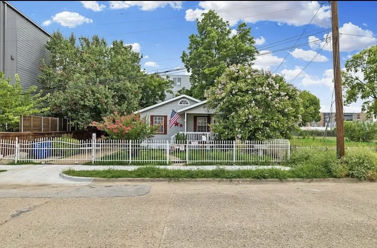 White picket fence with gated driveway entrance