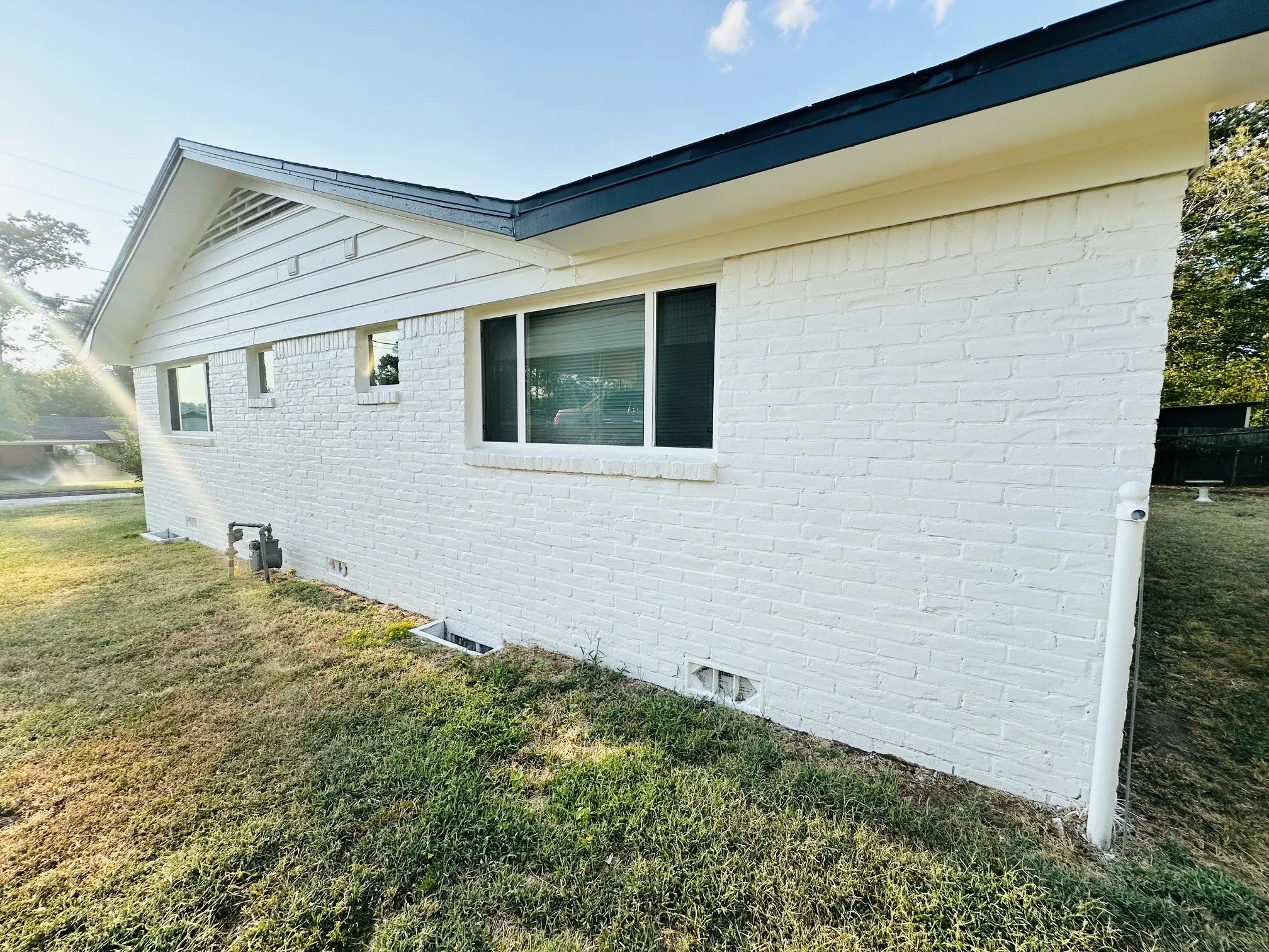 White-painted brick exterior with a dark roofline