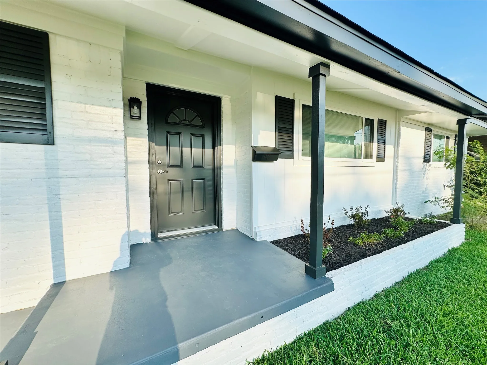 White brick exterior with dark trim accents