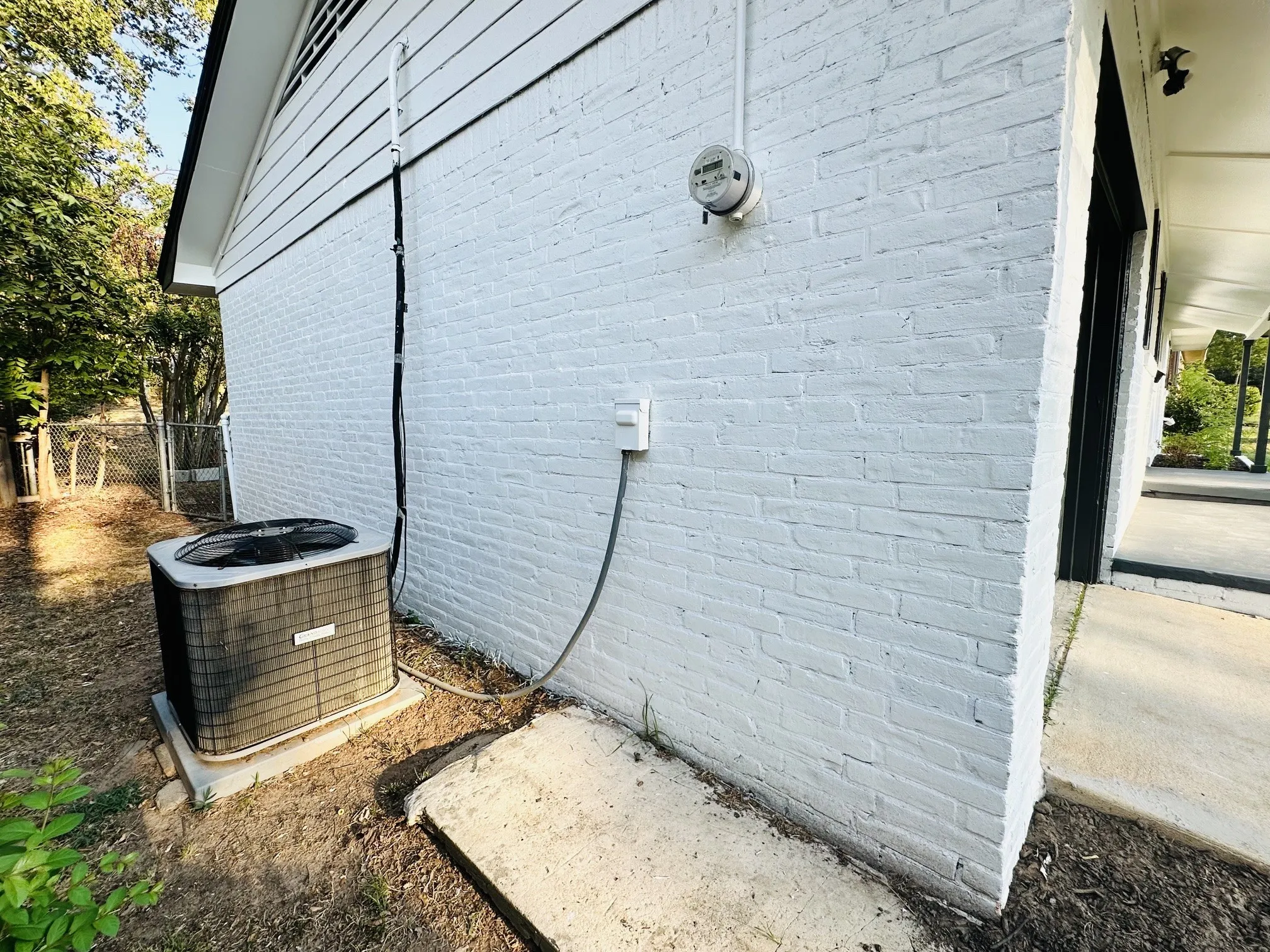 Painted brick exterior with a visible HVAC unit