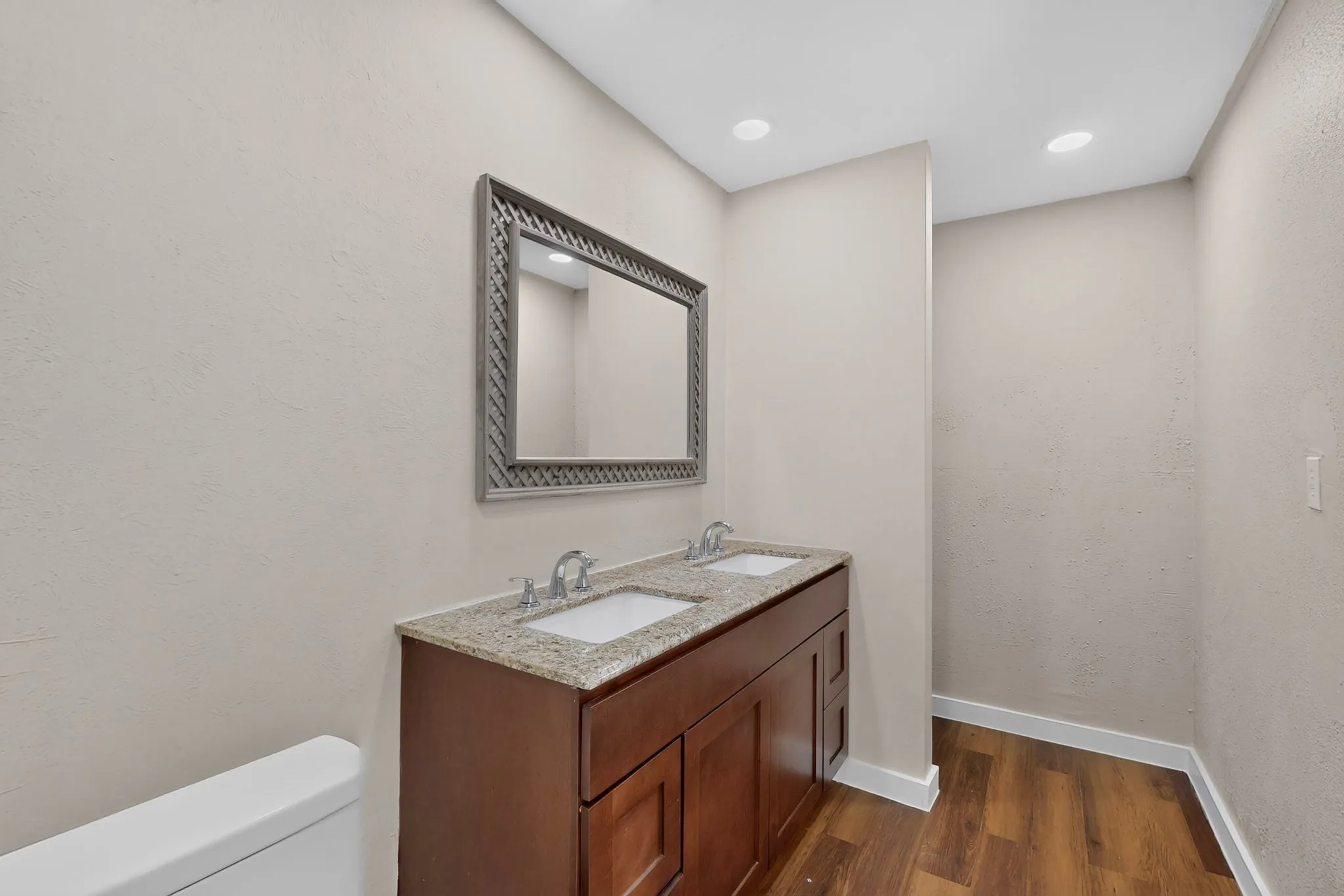Dual vanity with a stone countertop and integrated sinks