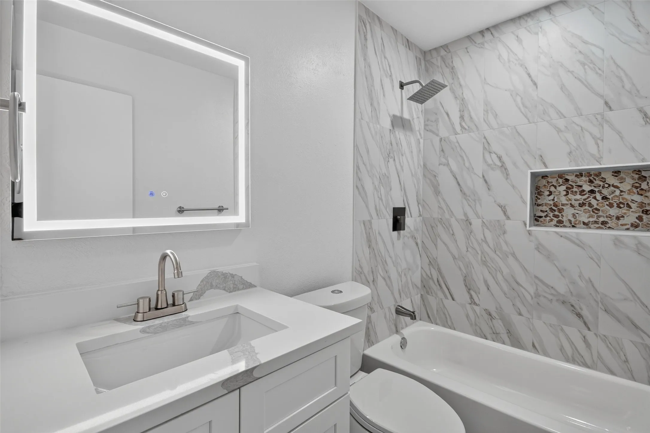Integrated vanity with a white countertop and undermount sink