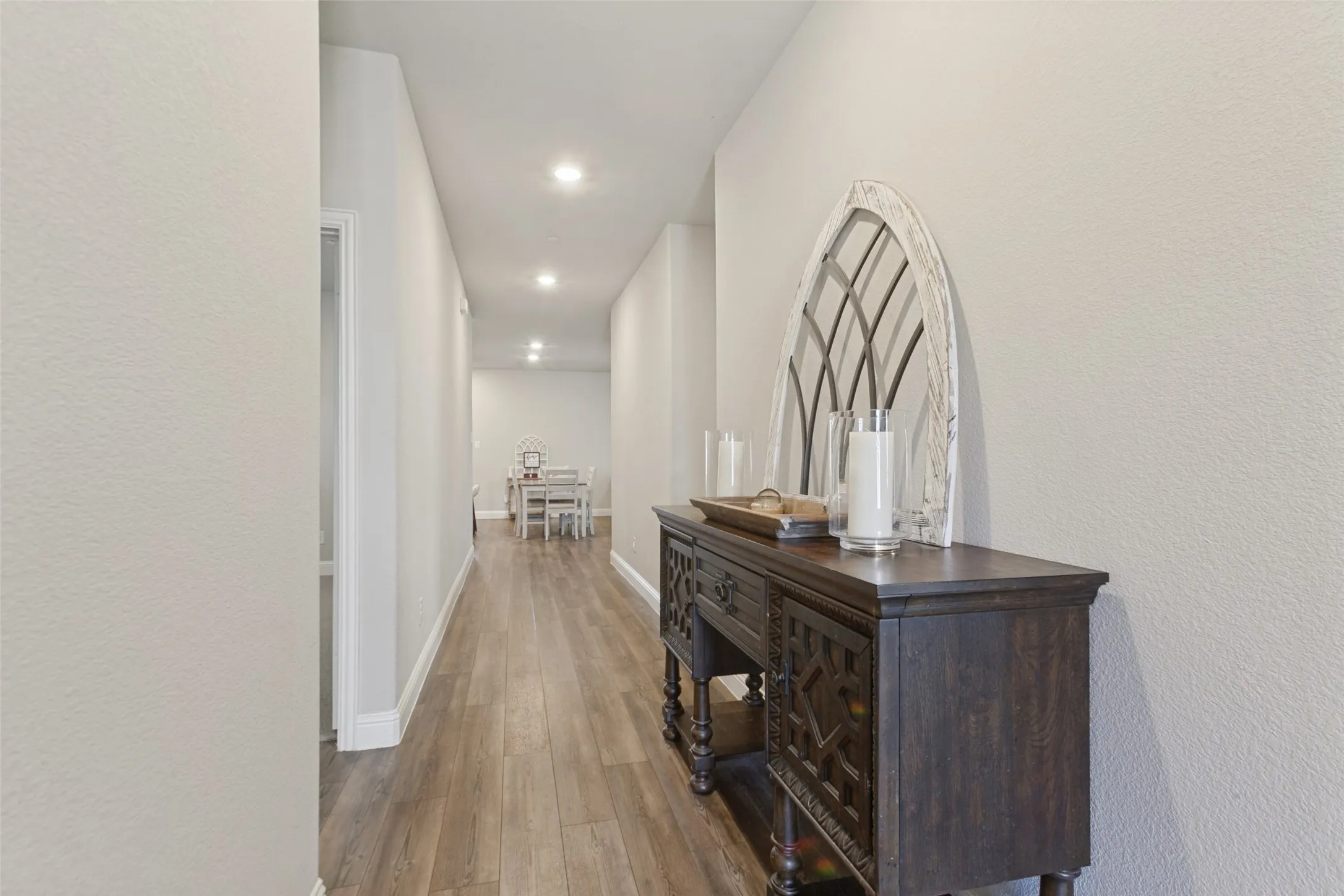 Wood-finish flooring throughout, recessed lighting, and crisp white walls