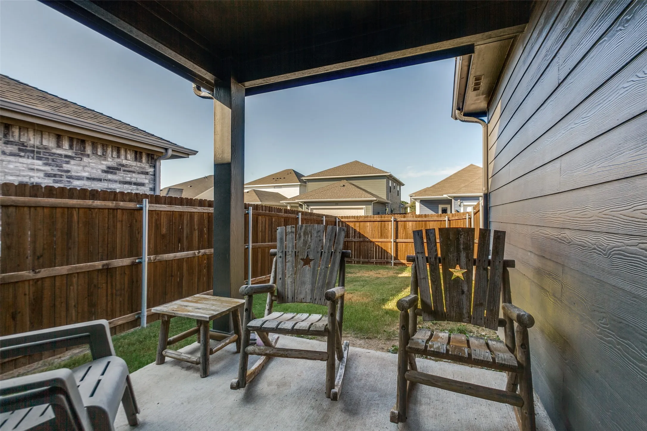 Covered patio featuring a concrete slab and wood-finish siding