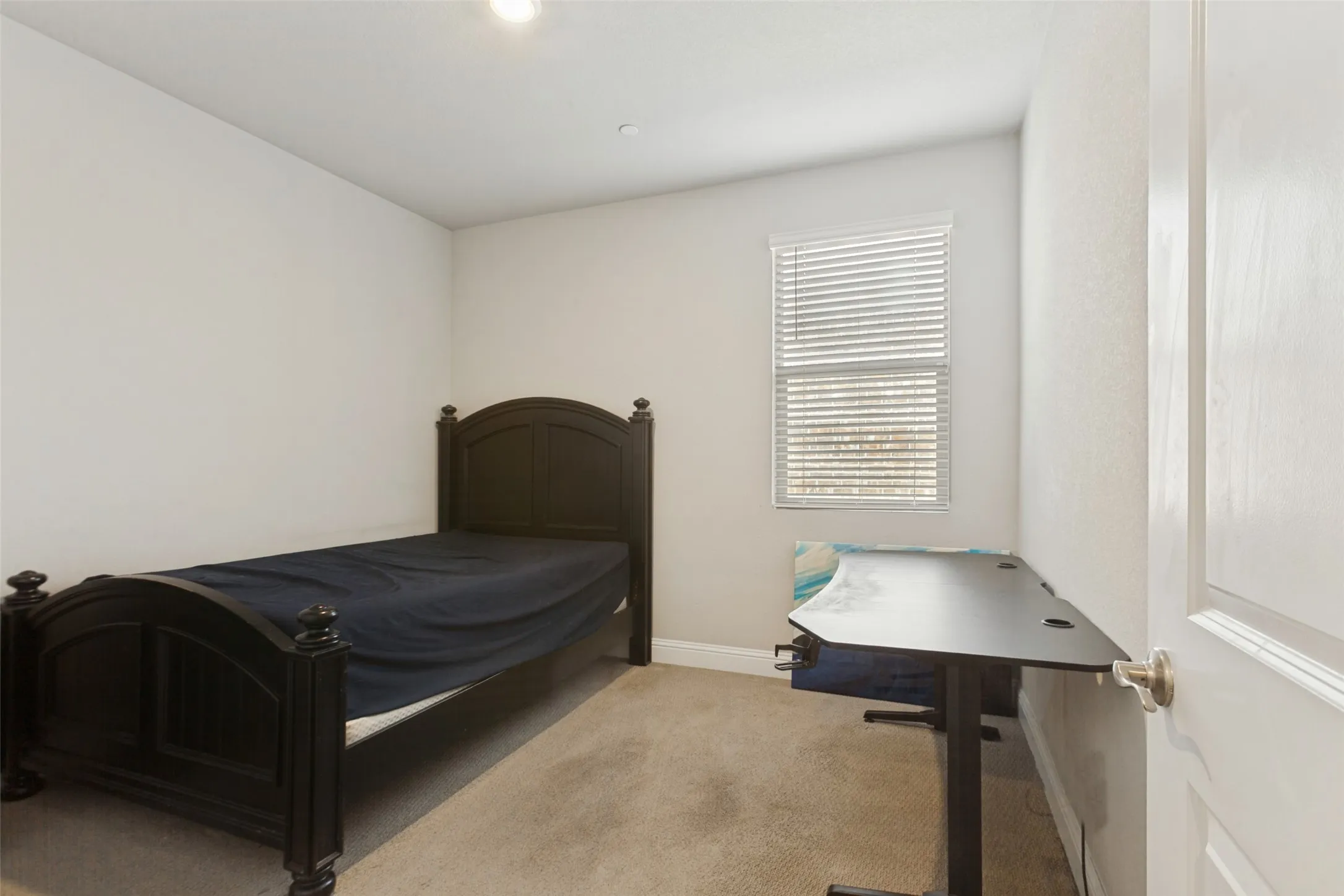 Recessed lighting, window with horizontal blinds, neutral wall paint, and carpeted flooring