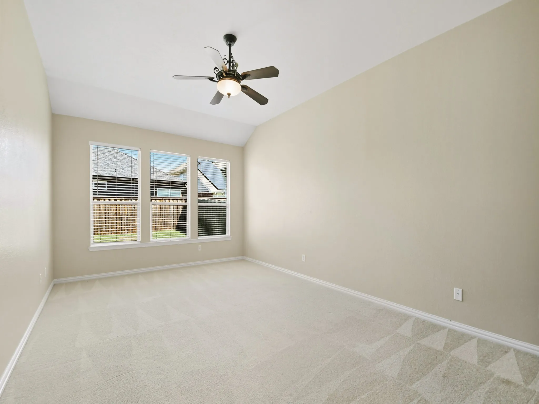 Primary Bedroom Vaulted ceiling with an attached ceiling fan and light fixture