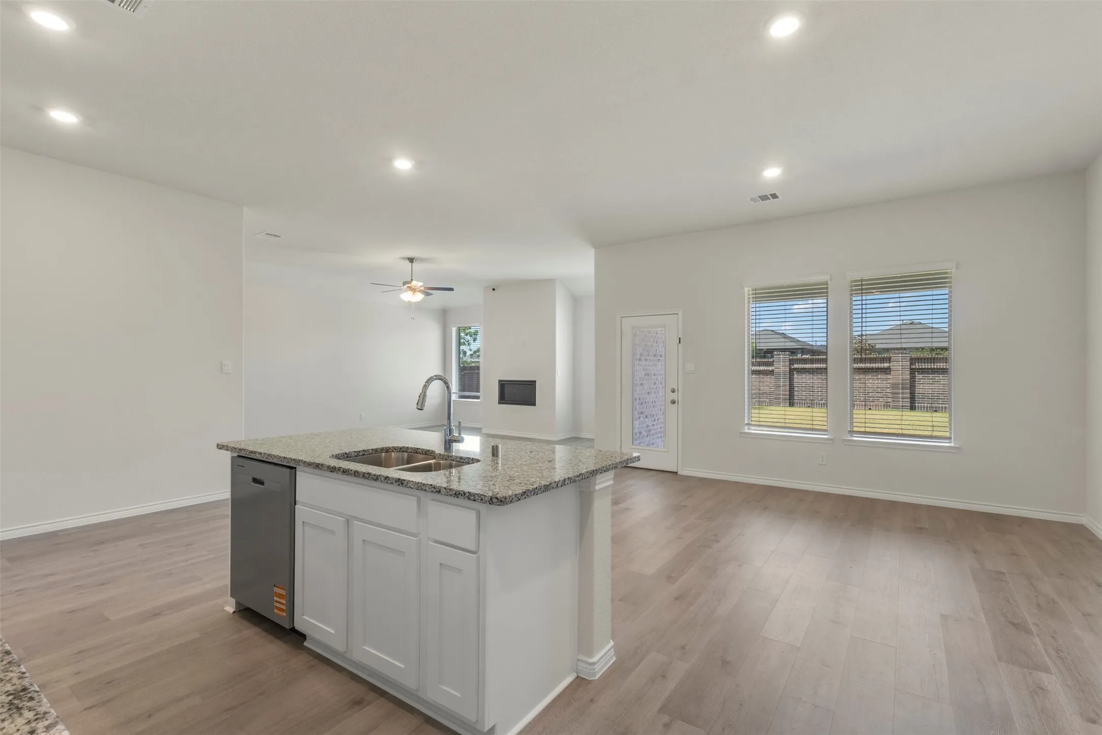 Kitchen island with a double basin sink, gooseneck faucet, and integrated dishwasher