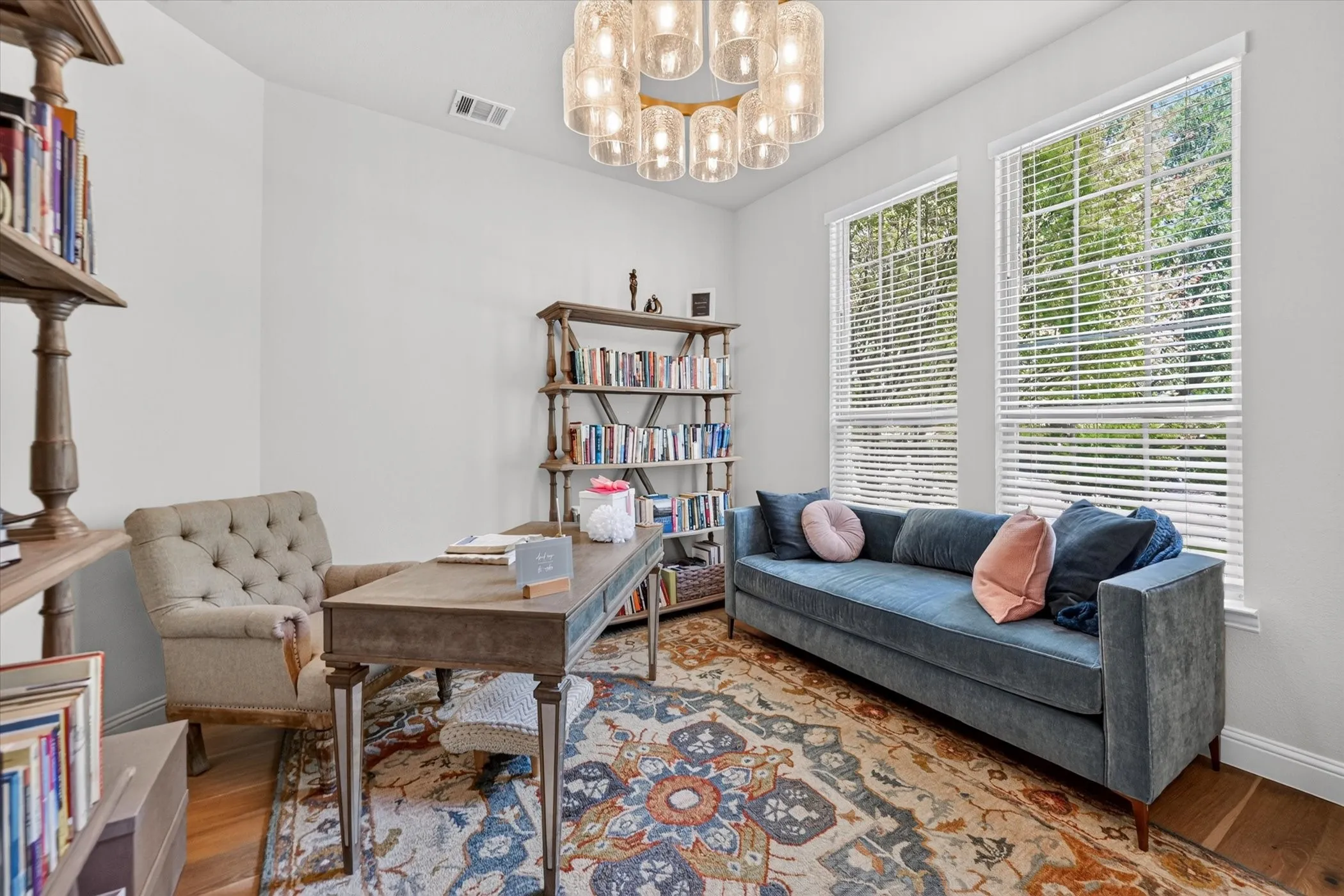 Recessed lighting, wood-finish flooring, and a decorative ceiling fixture