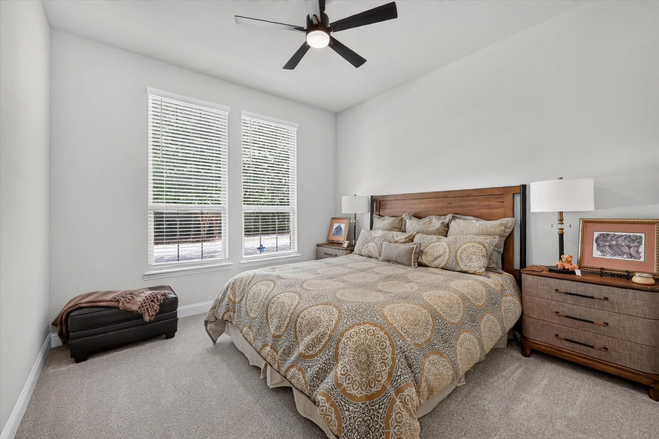Vaulted ceilings with a ceiling fan, dual windows with blinds, light gray wall paint, and gray carpeting