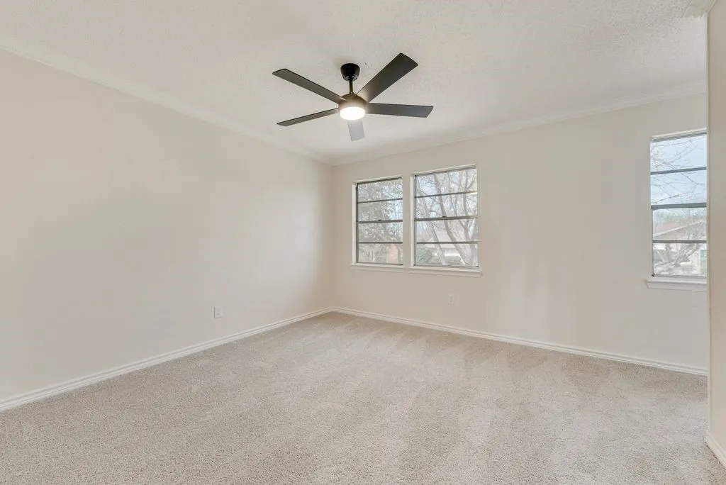 Recessed lighting with a ceiling fan, crown molding, multiple windows, and carpet flooring