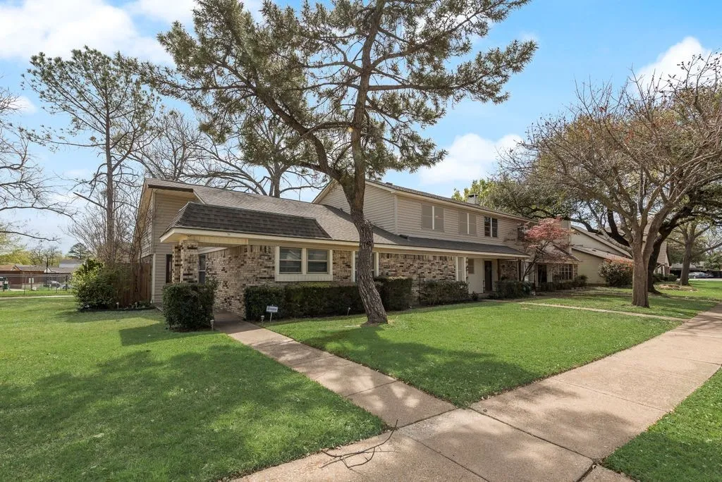 Brick and siding exterior with a shingled roof