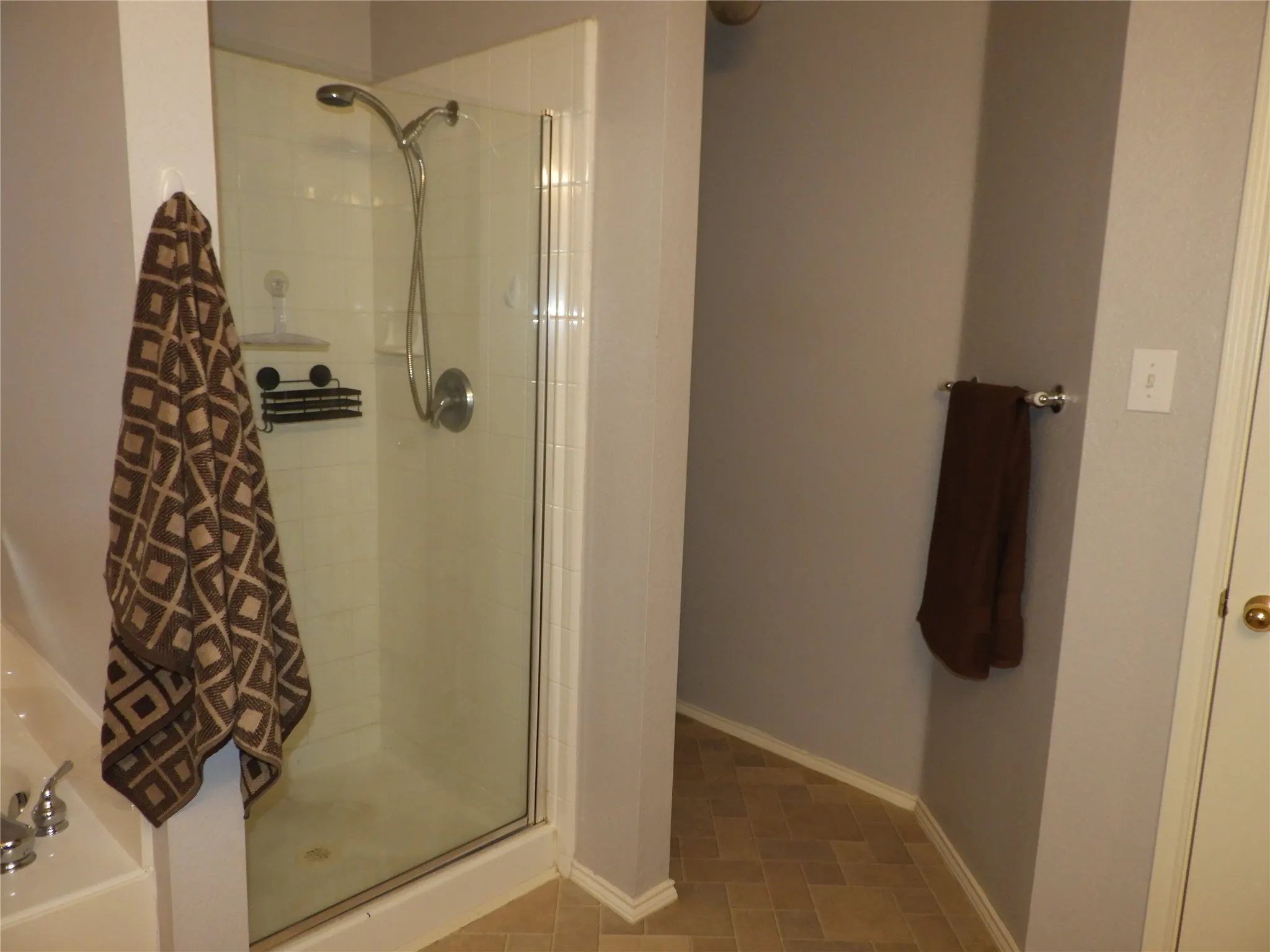 Another view of Primary Bathroom featuring standing shower and privacy space.