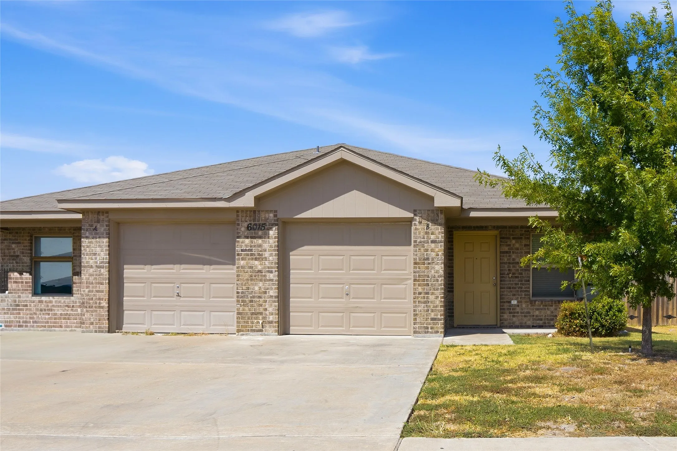 Brick exterior with a gabled roof and attached two-car garage