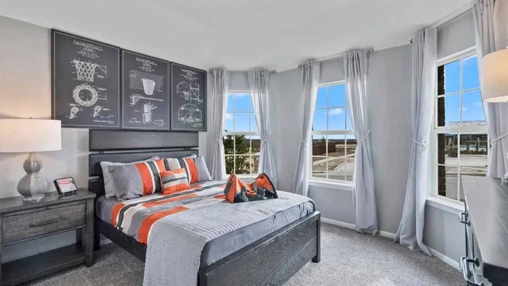 Room featuring multiple windows, light gray wall paint, and gray carpeting