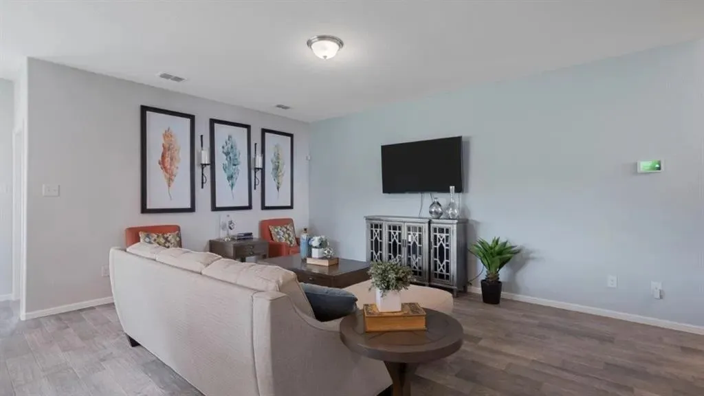 Wood-finish flooring throughout, light-toned walls, and a mounted ceiling light fixture