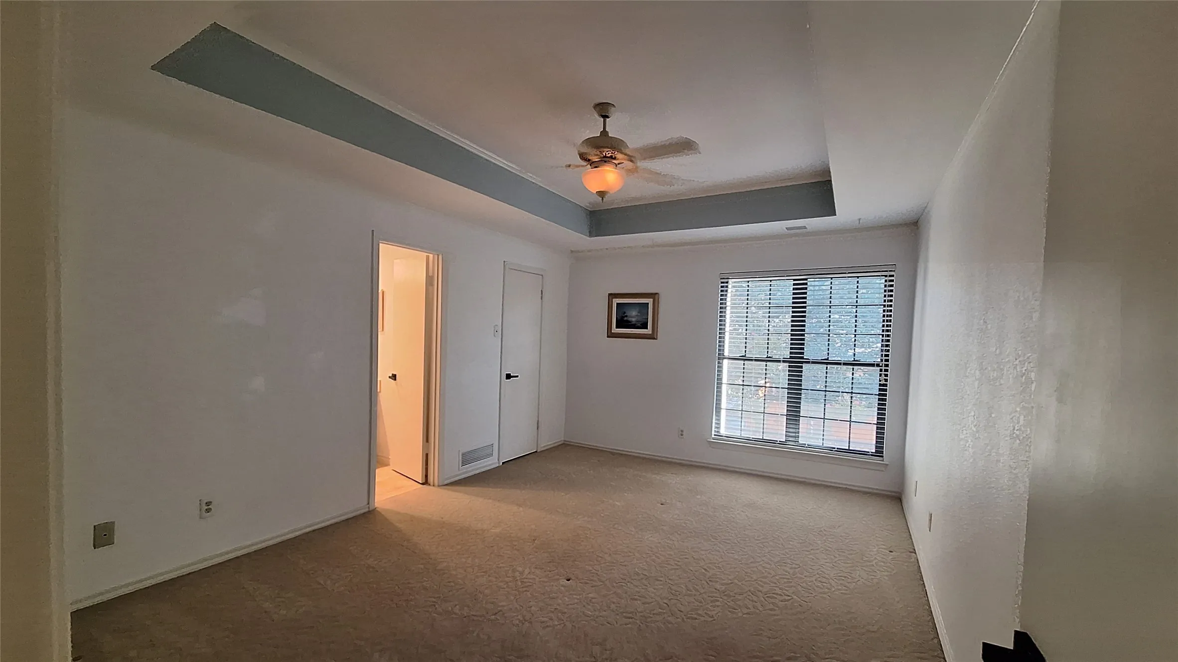 nice bright master bedroom with accent trim raised ceiing, fan, WI closet, new blinds to enjoy backyard view