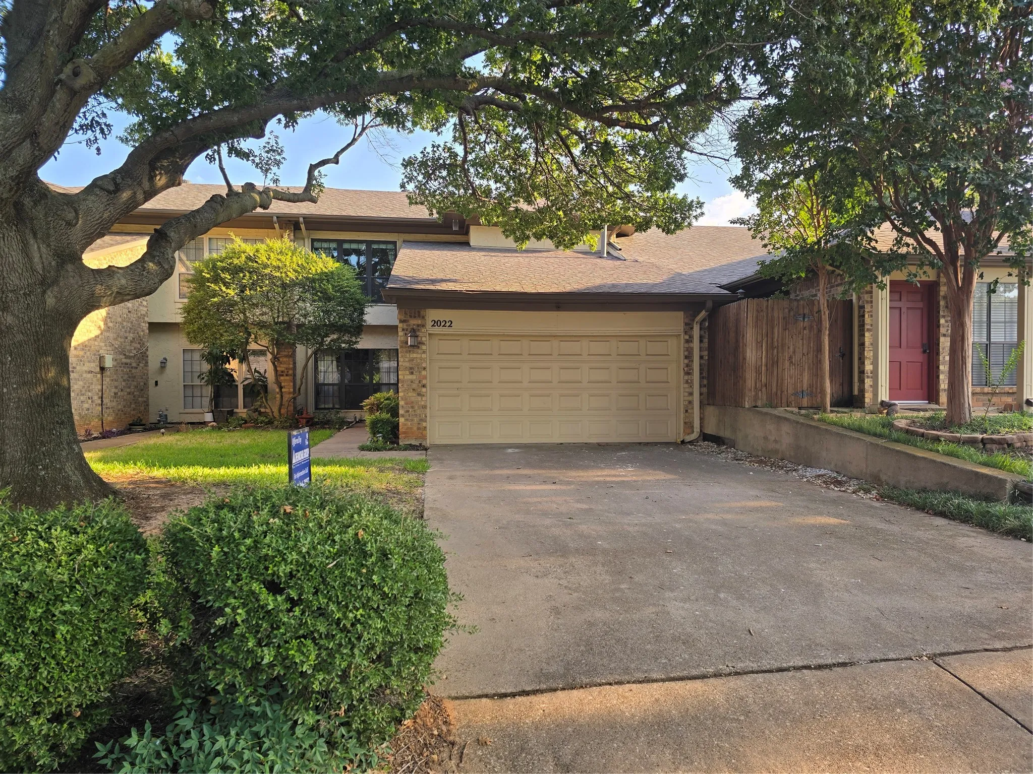 north facing townhome with wall of windows at first floor den and 2nd floor front BR 3 or gameroom