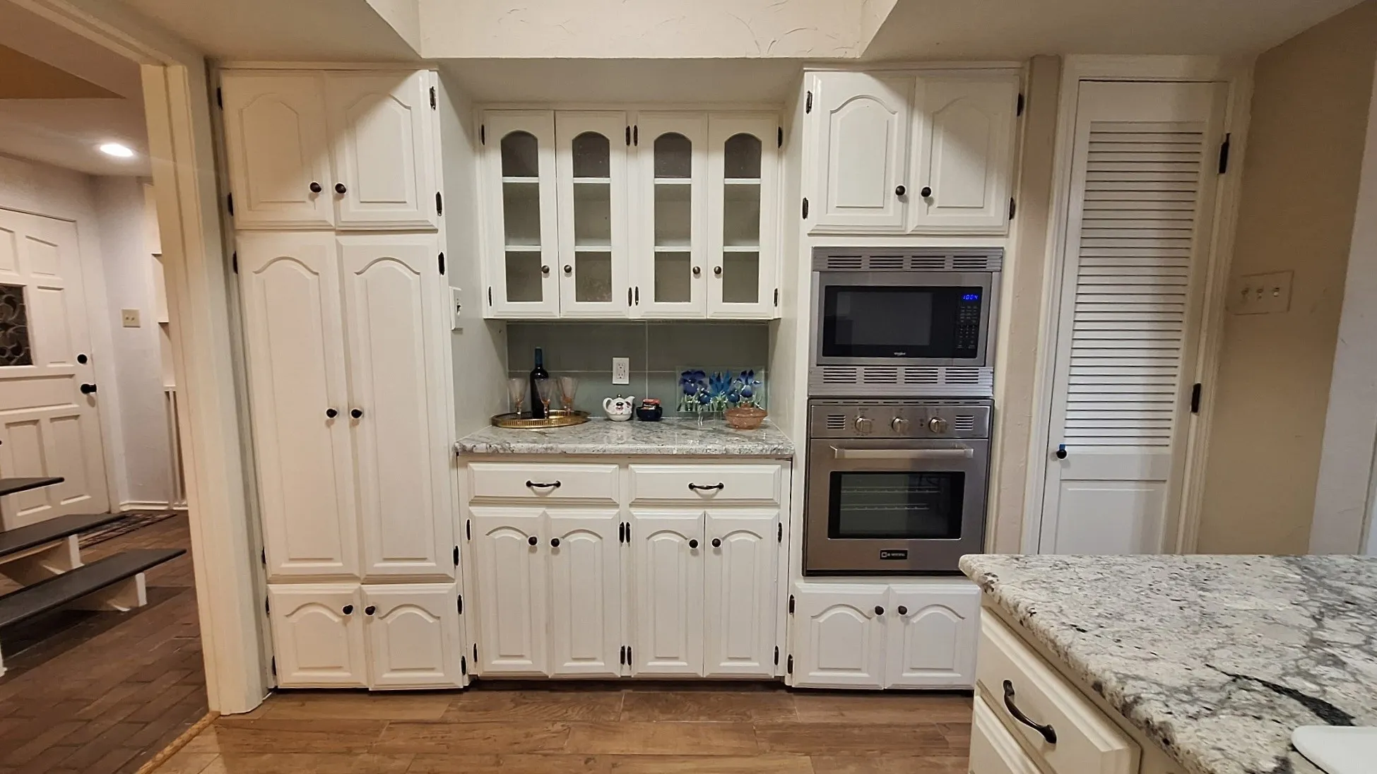wine and coffee bar flanked by 2 pantries, open case door way back to entry hall