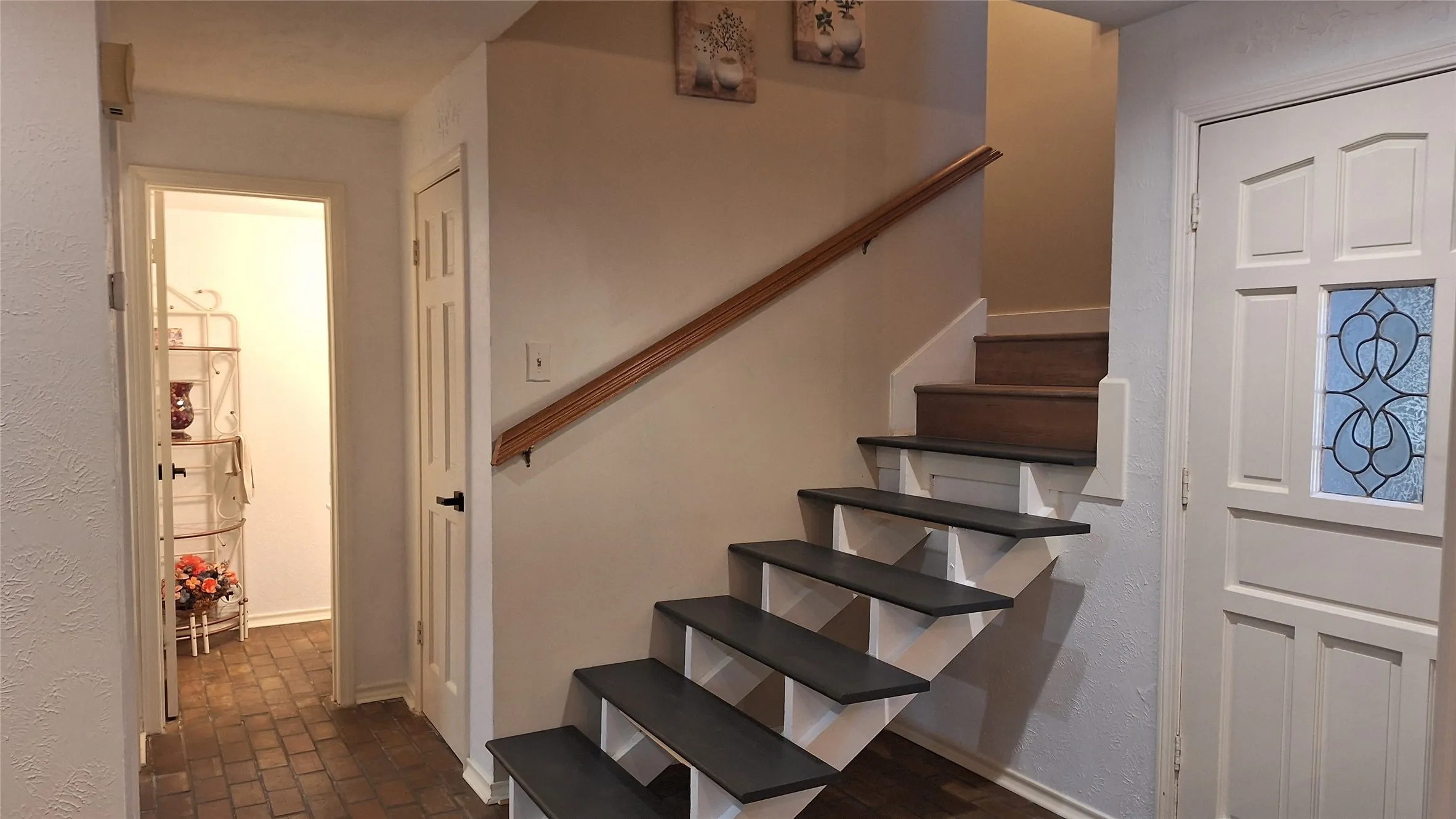 wood stairs to 2nd floor, door into guest bath