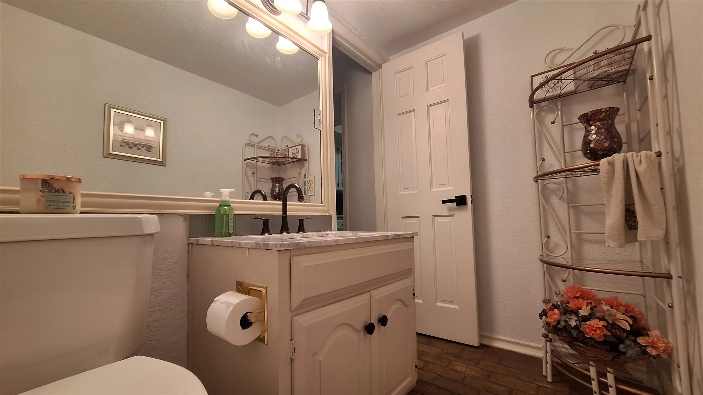 guest bath with new toilet and marble vanity top