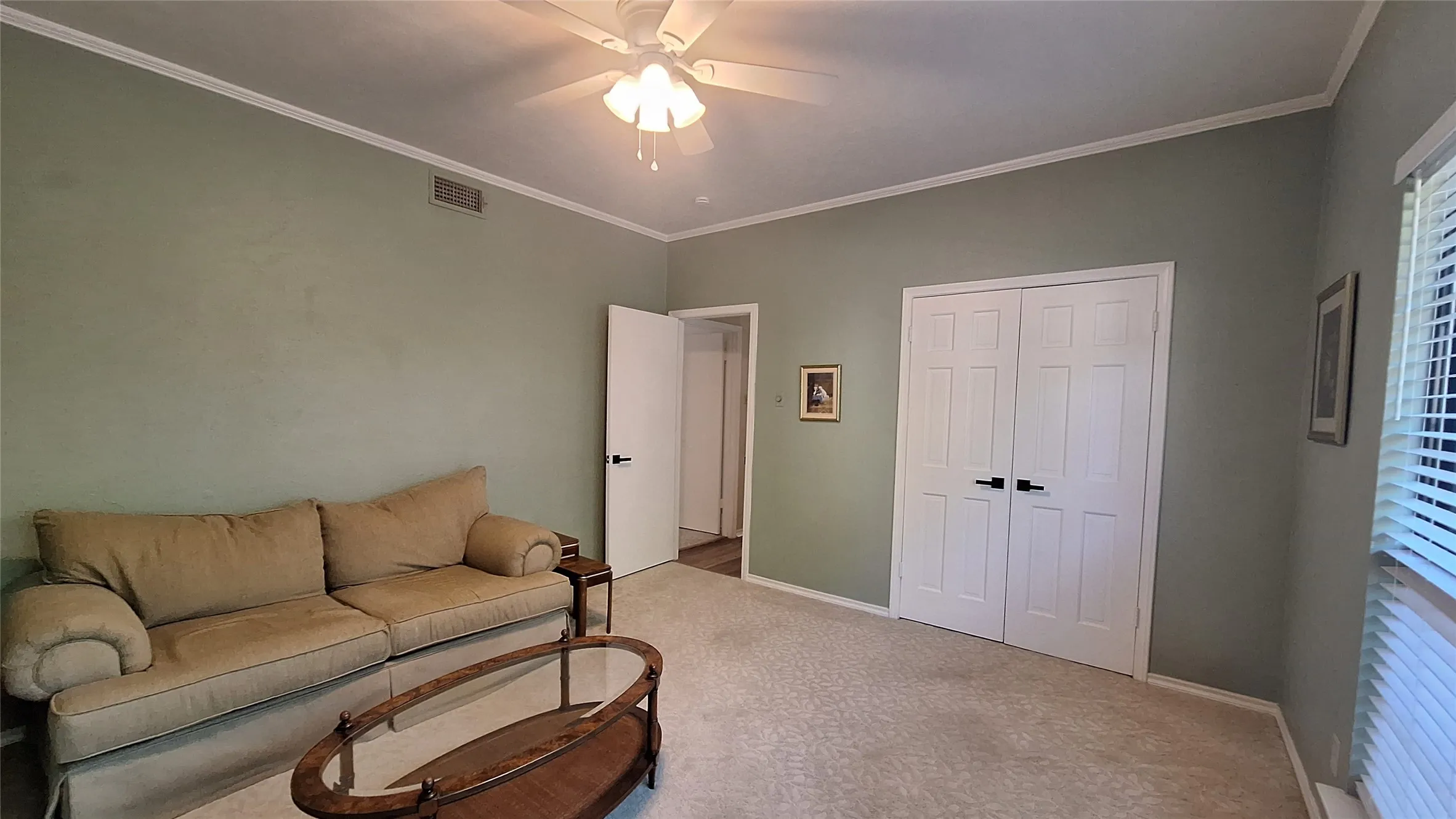 bright room with new wood blinds & fan, full wall closet, crown mold accent trimm loveseat and coffe table are available