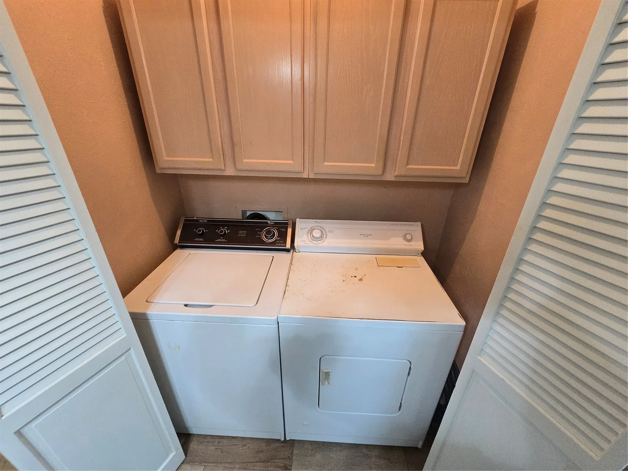 Utility closet off breakfast room with washer and dryer & cabinet storage