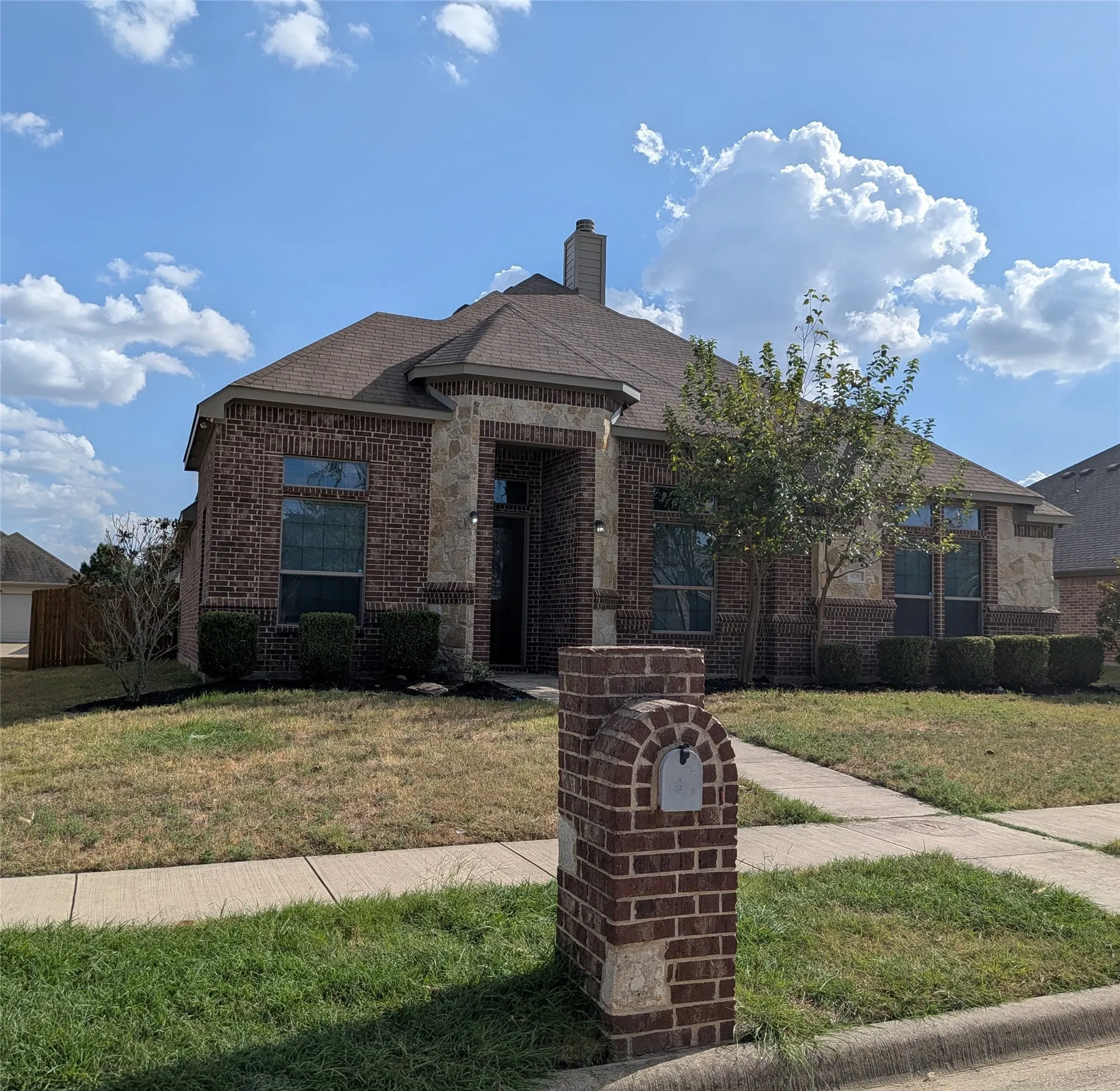 Elegant brick exterior with arched entryway and stone accents
