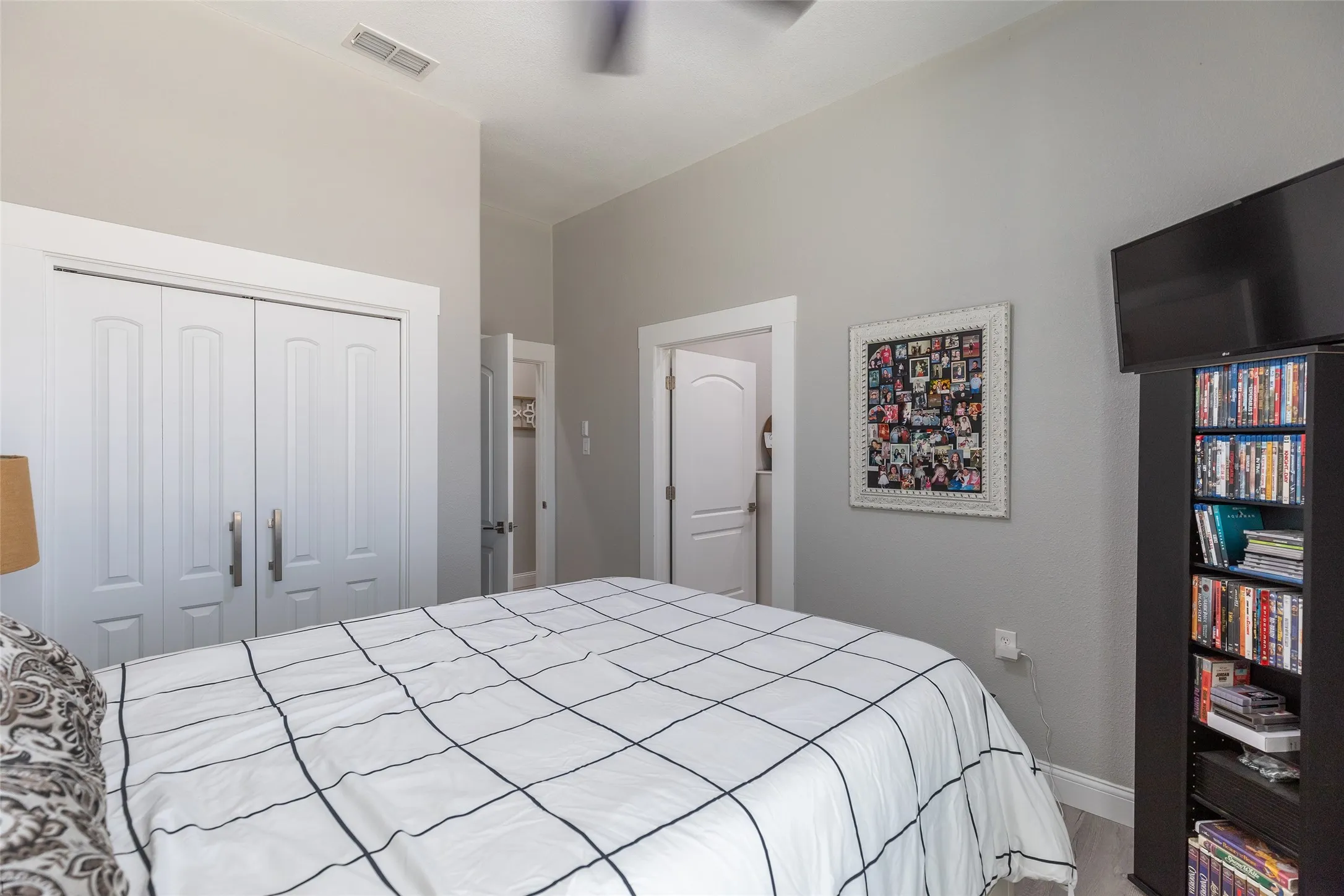 Tray ceiling with a ceiling fan, light gray wall paint, and white trim