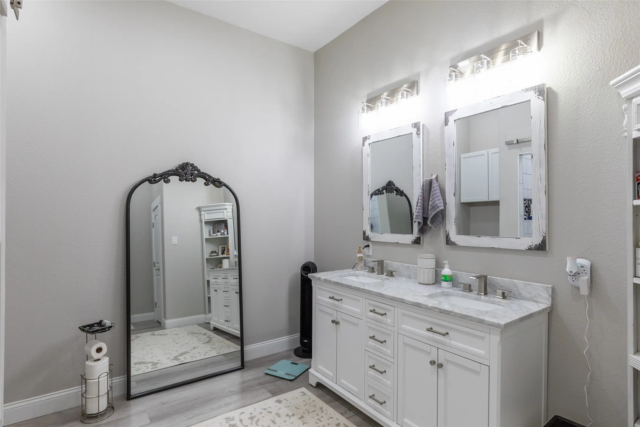 Dual vanity with stone countertop, undermount sinks, and brushed nickel fixtures