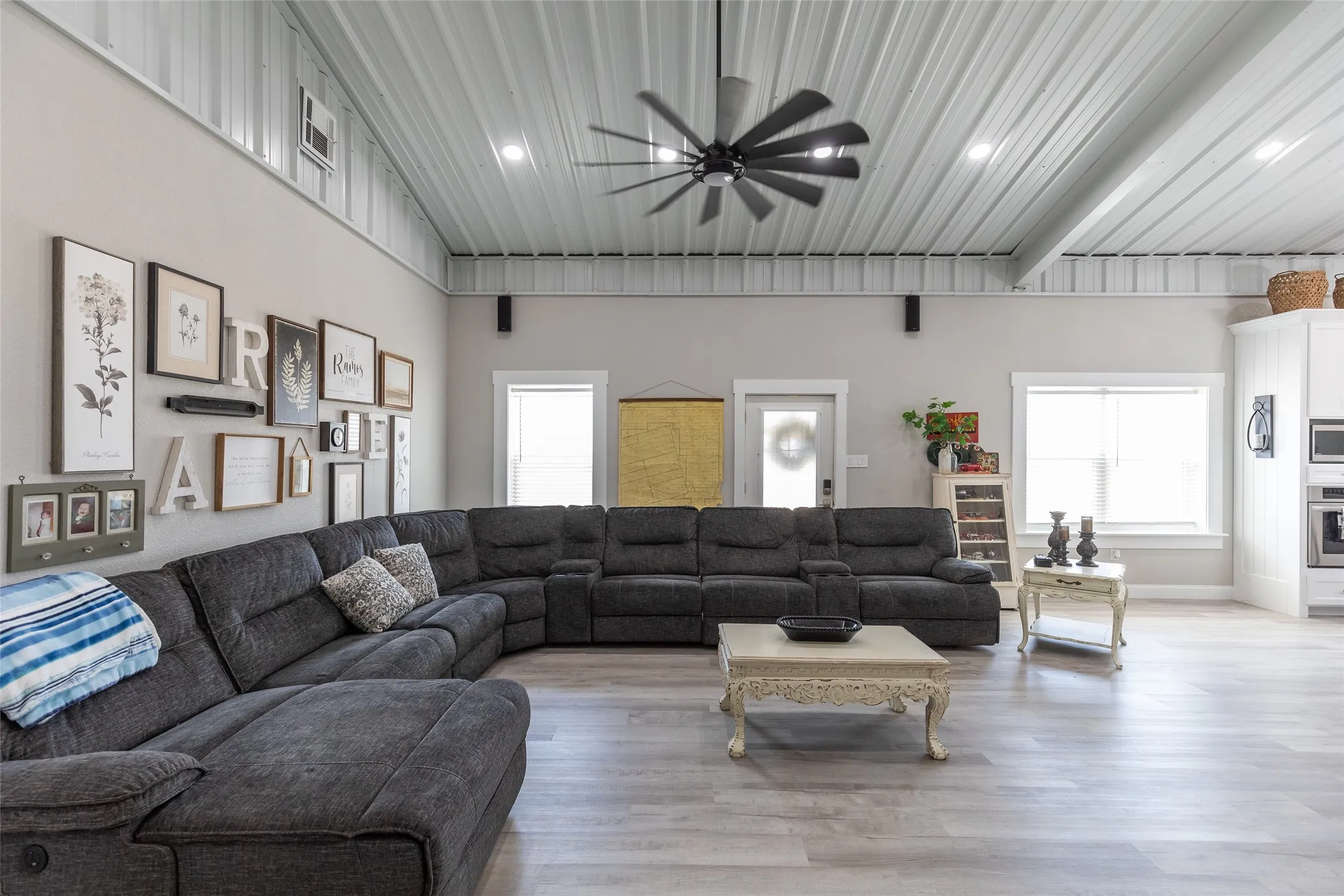 Vaulted ceiling with exposed metal beams and recessed lighting