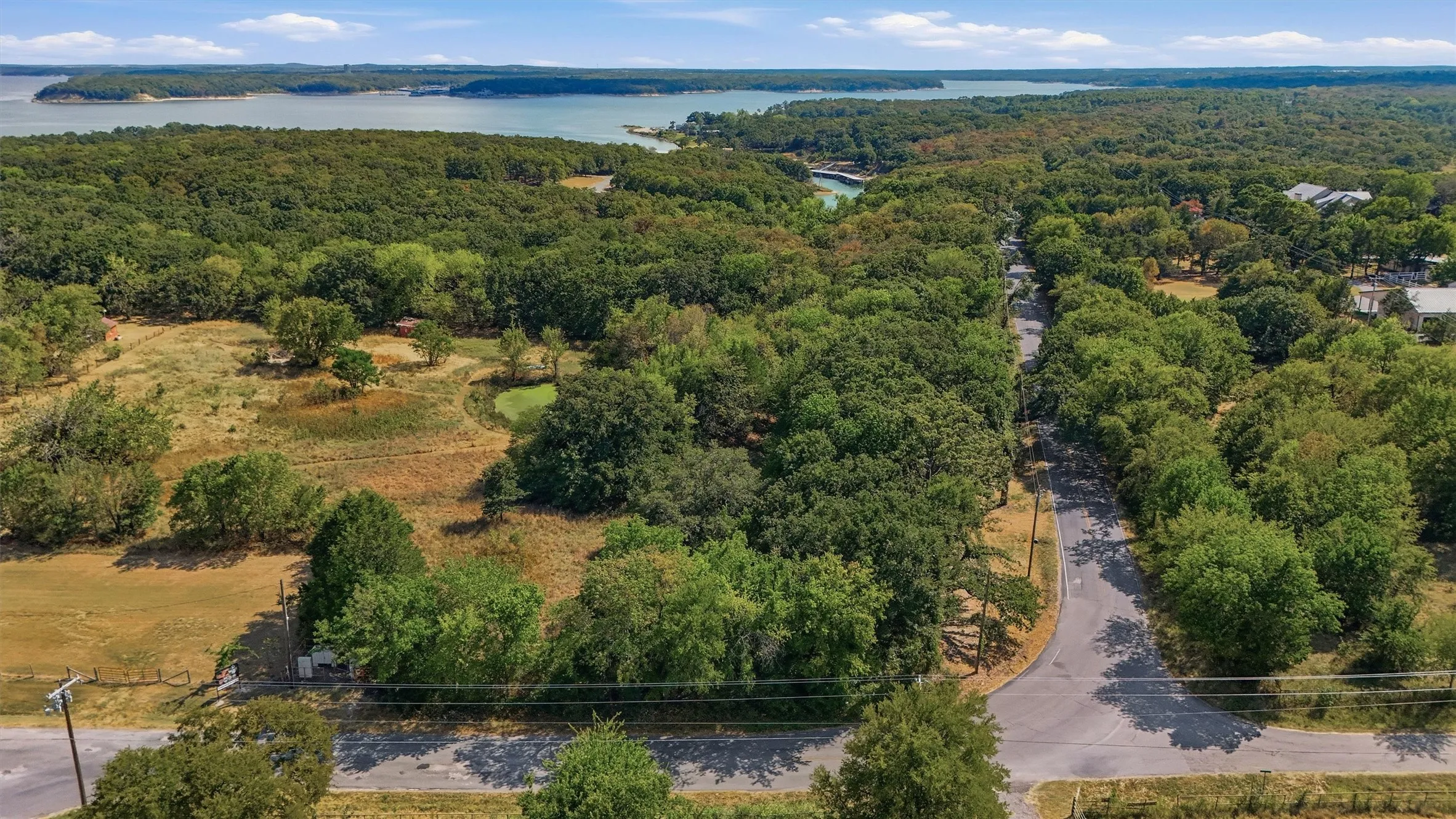 Expansive acreage featuring mature trees, a natural pond, and partial fencing