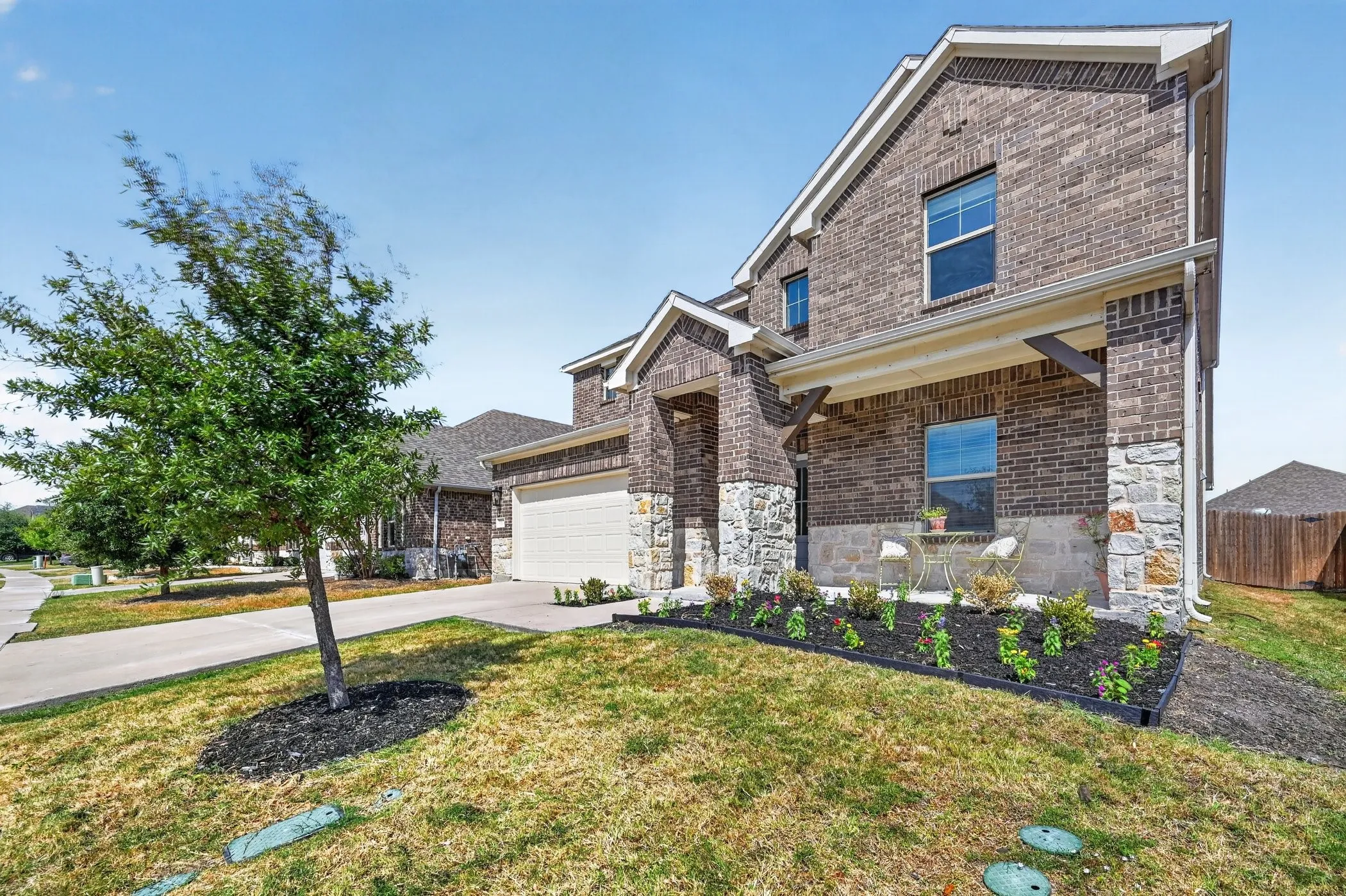 Brick and stone exterior with a covered front porch