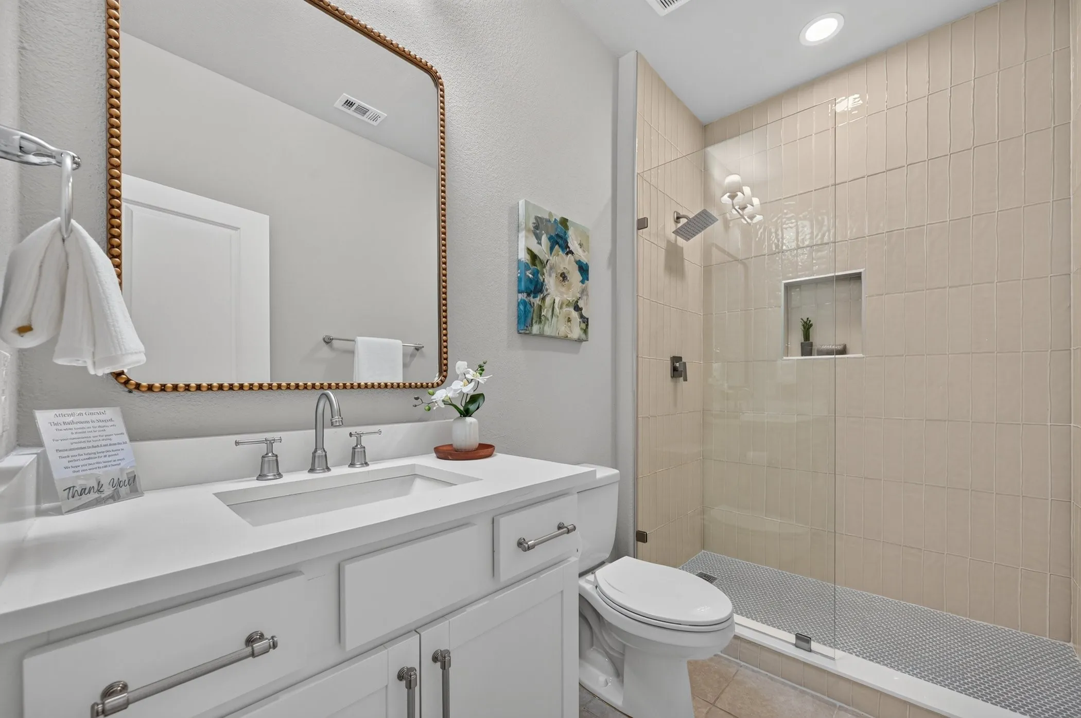 Modern vanity with white cabinetry, integrated sink, and brushed nickel fixtures