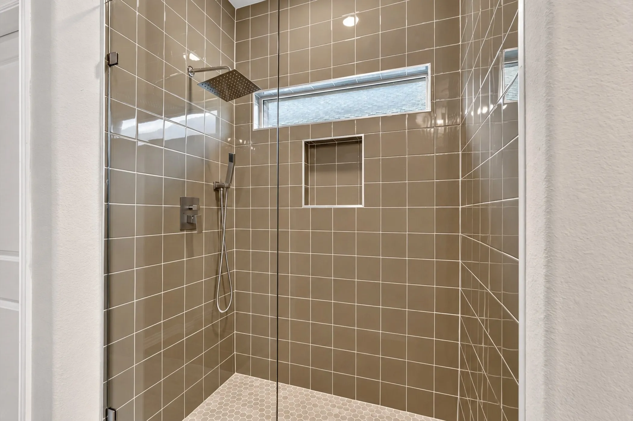 Bathroom featuring a single vanity with an integrated sink, polished chrome faucet, and white cabinetry