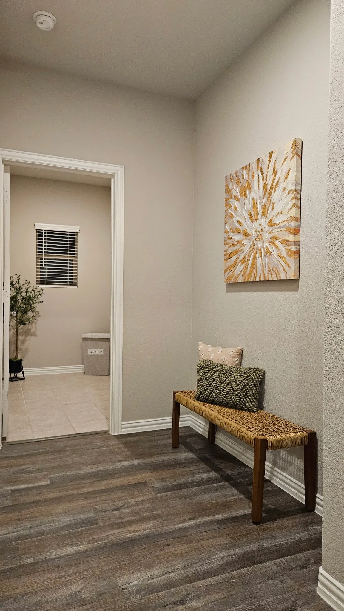 Wood-finish flooring throughout, complemented by white trim and neutral wall tones