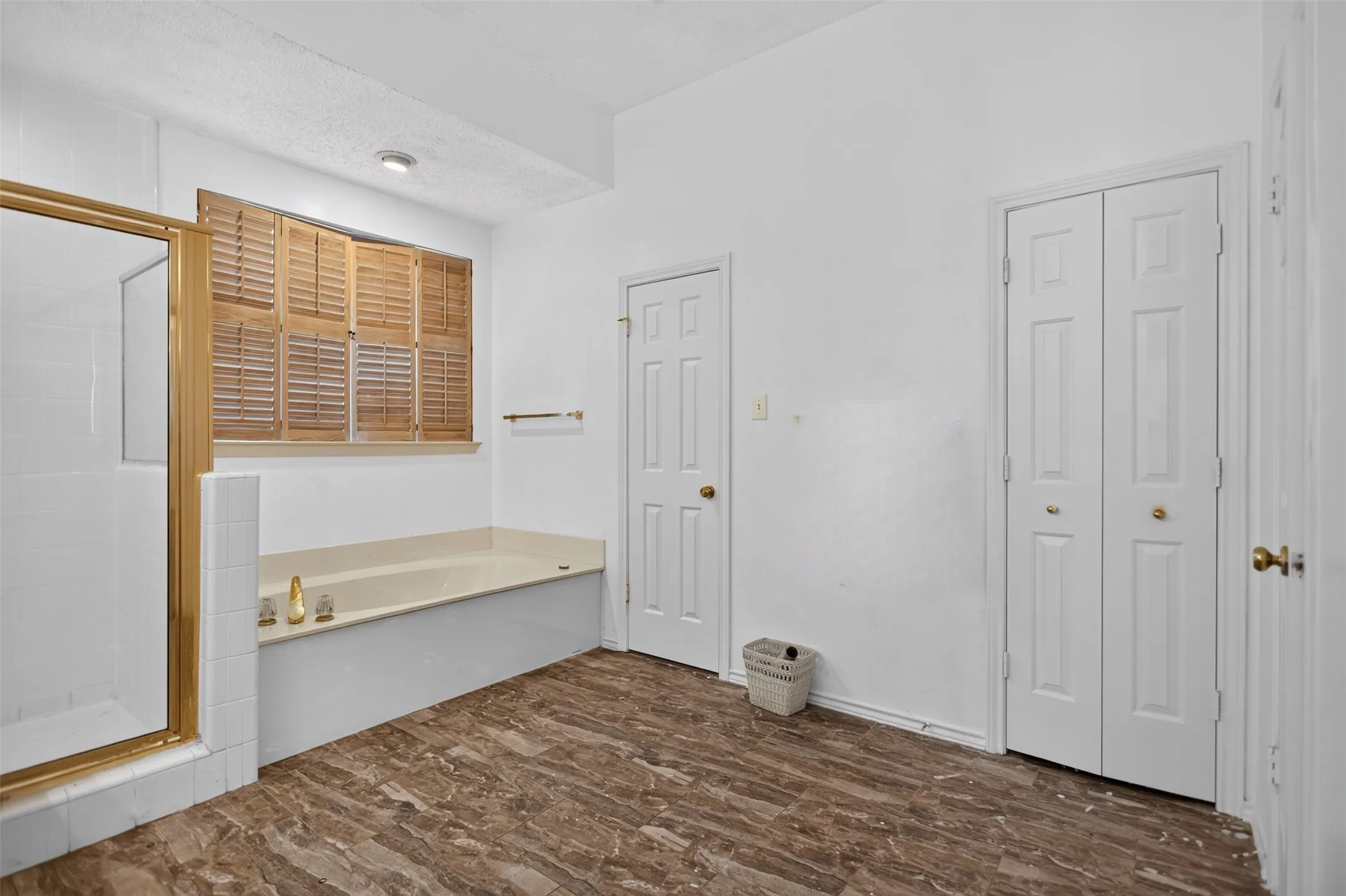 Soaking tub with adjacent shower enclosure